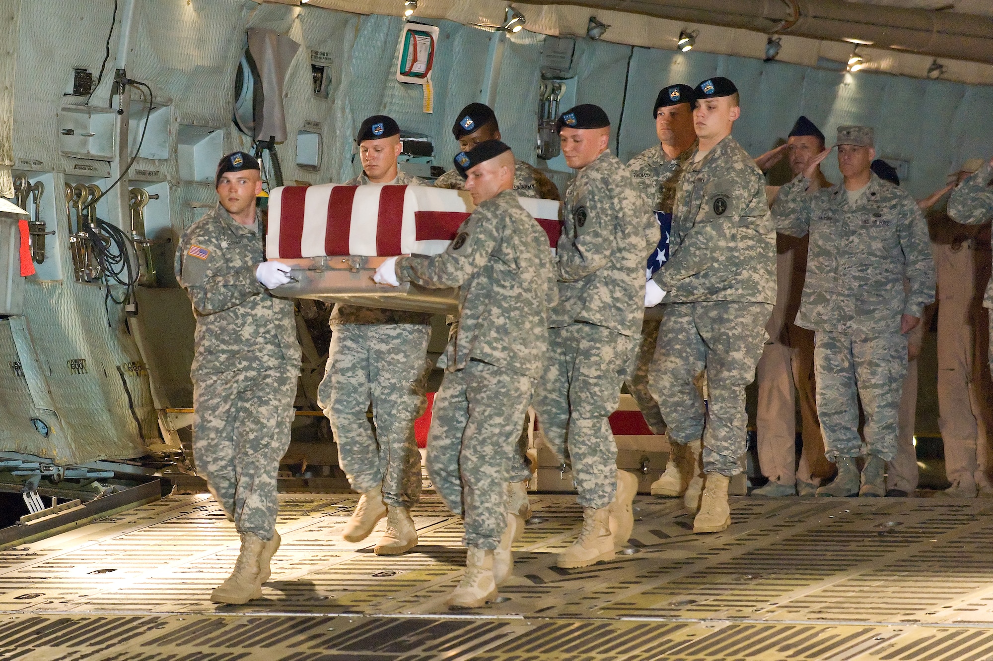 A U.S. Army carry team transfers the remains of Army Pfc. Christopher B. Fishbeck, of Victorville, Calif., at Dover Air Force Base, Del., June 8, 2011. He was assigned to the1st Battalion, 7th Field Artillery Regiment, 2nd Heavy Brigade Combat Team, 1st Infantry Division, Fort Riley, Kan. (U.S. Air Force photo/Roland Balik)
