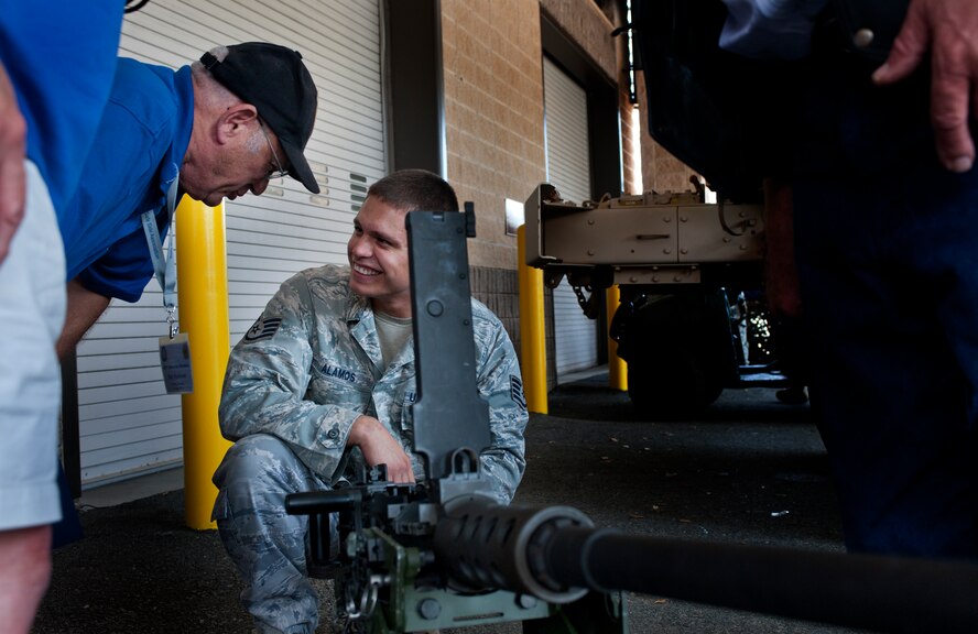 MOODY AIR FORCE BASE, Ga. -- Jancey Alamos, 820th Combat Operations Squadron combat arms instructor, talks with retired Master Sgt. Rick Mazzacua, former 7th Air Force intelligence specialist, about an M2 machine gun. During the static display, veterans got a chance to see the weapons and equipment used by today’s troops. (U.S. Air Force photo/Airman 1st Class Jarrod Grammel)(RELEASED)