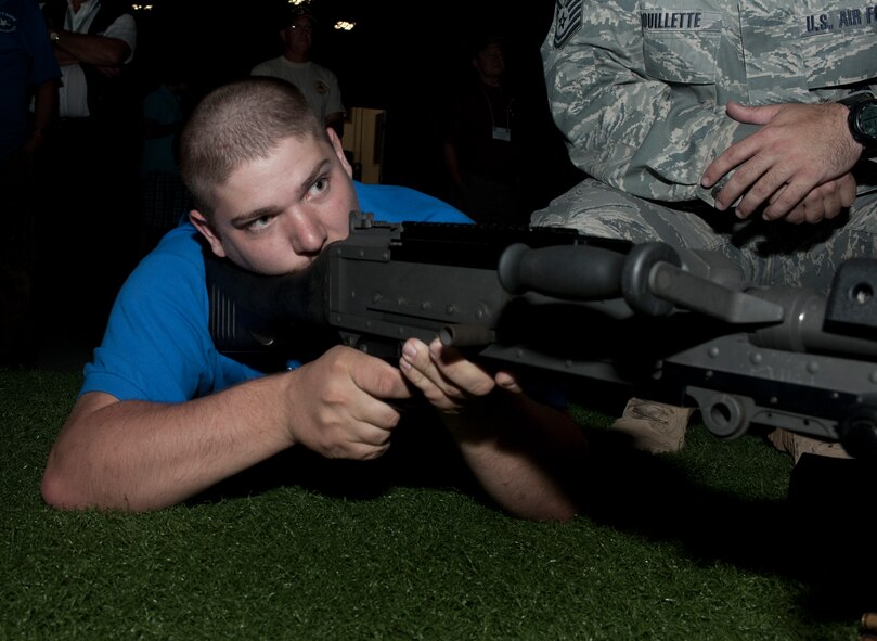 MOODY AIR FORCE BASE, Ga.-- Wesley “Rambo” Cole, son of Safeside member retired Tech. Sgt. Kenneth Cole Sr., operates a simulated M240B machine gun at the engage skills trainer during a Safeside reunion June 4. Mr. Cole got his nickname after operating an M2 machine gun at the engage skills trainer during the 2009 Safeside reunion at Moody. (U.S. Air Force photo/Airman 1st Class Jarrod Grammel)(RELEASED)