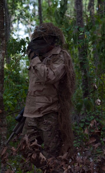 MOODY AIR FORCE BASE, Ga. -- Senior Airman Shane Lafever, 823rd Base Defense Squadron fire team member, emerges from his concealment during a military operations in urban terrain demonstration during a Safeside reunion June 4. After the MOUT demonstration, members of the Safeside Association said they were proud of the present-day Safesiders. (U.S. Air Force photo/Airman 1st Class Jarrod Grammel)(RELEASED)