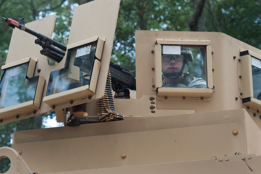 MOODY AIR FORCE BASE, Ga. -- Senior Airman James Lewis, 823rd Base Defense Squadron gunner, covers his team members during a military operations in urban terrain demonstration during a Safeside reunion June 4. Airman Lewis manned an M240B machine gun, which is similar to the M60 machine used by the 82nd Combat Security Police Wing during the Vietnam War. (U.S. Air Force photo/Airman 1st Class Jarrod Grammel)(RELEASED)