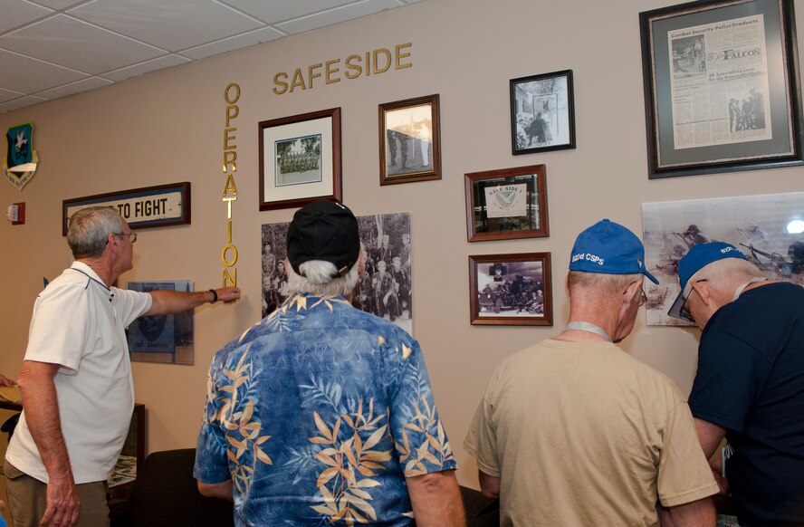MOODY AIR FORCE BASE, Ga. -- Members of the Safeside Association look at memorabilia dedicated to them during a tour of the 820th Base Defense Group building June 4. During the Vietnam War, these veterans were part of the 82nd Combat Security Police Wing, which would later be reactivated as the 820th Security Forces Squadron. (U.S. Air Force photo/Airman 1st Class Jarrod Grammel)(RELEASED)