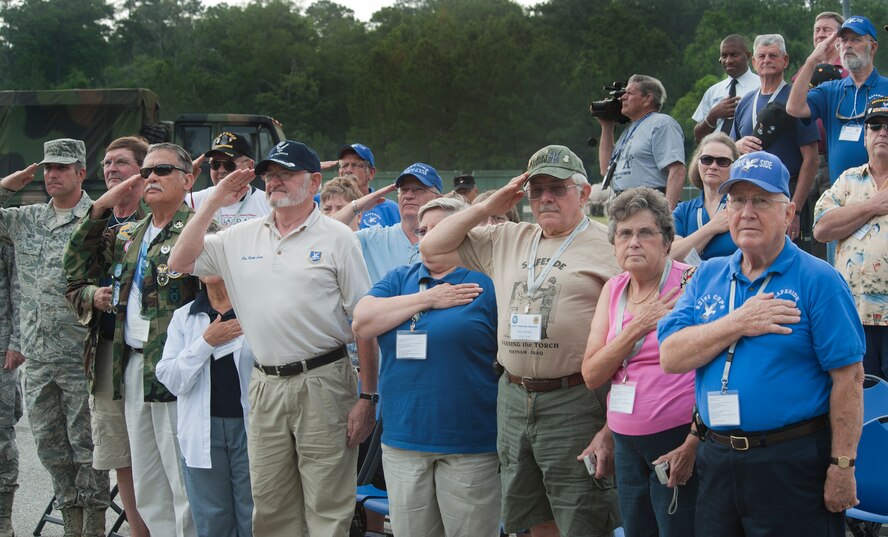MOODY AIR FORCE BASE, Ga. -- Veterans and Airmen pay their respects during the playing of the national anthem during a Safeside reunion June 4. Members of the Safeside Association visit Moody every two years to interact with their comrades, the 820th Base Defense Group. (U.S. Air Force photo/Airman 1st Class Jarrod Grammel)(RELEASED)