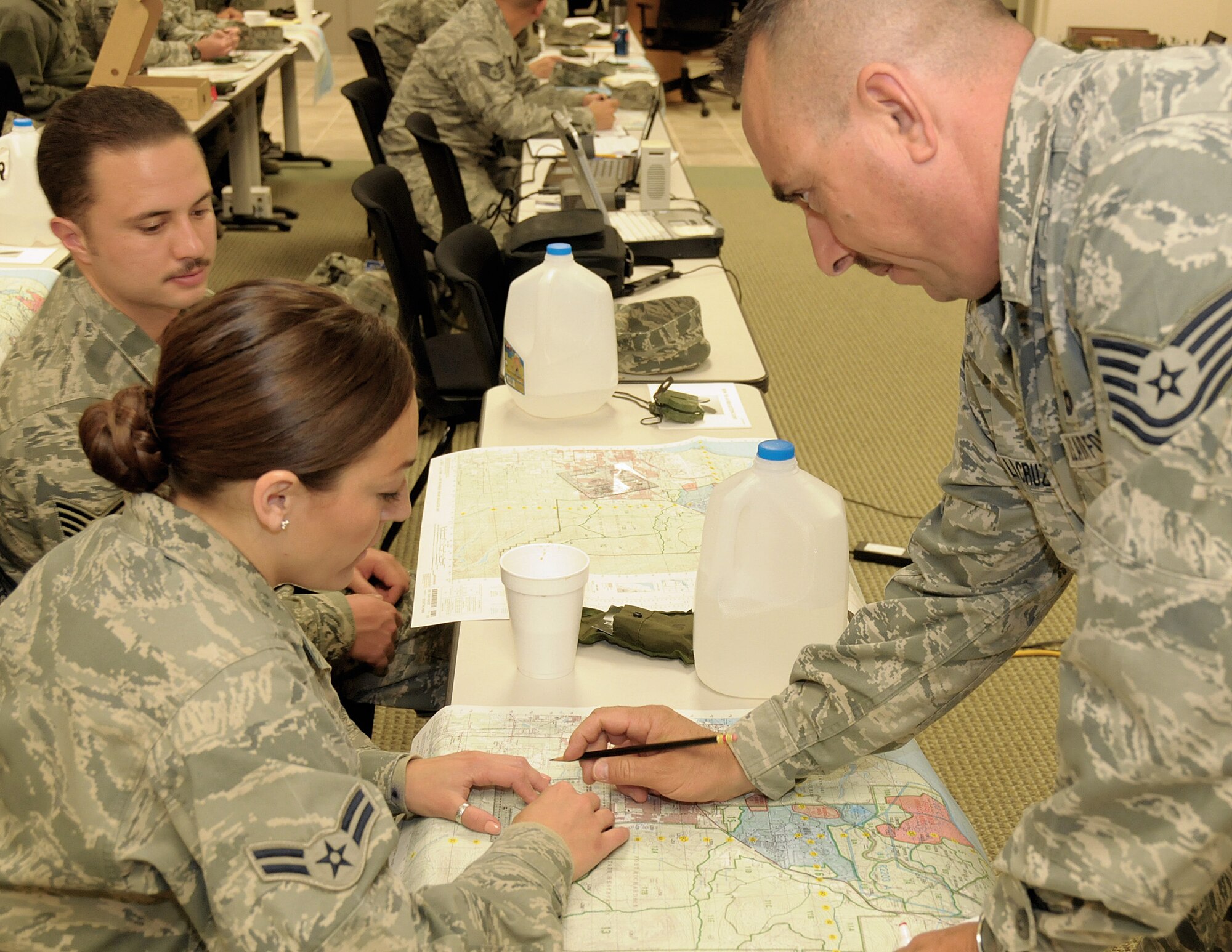 Technical Sergeant Marco De LaCruz, a member of the 146th Security Force Squadron, 146th Airlift Wing, Channel Islands Air National Guard Station, Calif. conducts a map reading course for 146 SFS personnel in preperation for an upcoming land navigation exercise. The 146 AW sent three squadrons to Joint Base Elmendorf-Richardson, Anchorage, Alaska on Saturday, June 4, 2011. The Air Terminal Operations Squadron, Logistics Readiness Squadron, and the Security Force Squadron moved down range to complete there respective annual training requirements.(Photo by Tech. Sgt. Alex Koenig)