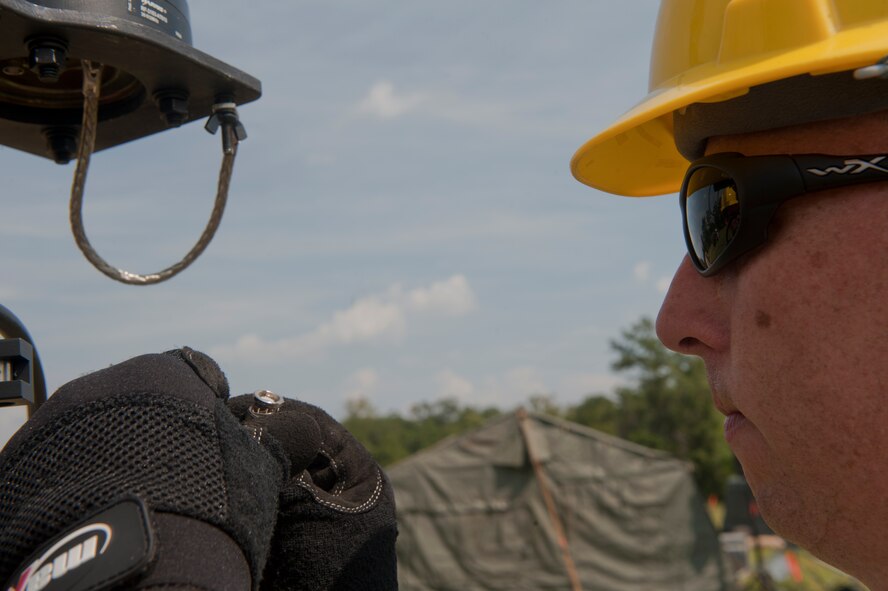 MOODY AIR FORCE BASE, Ga.--  Tech. Sgt. Michael Welch, 820th Combat Operations Squadron NCO in charge of radio frequency communications systems, prepares an antenna carrymast to be raised June 7. The carrymast is used to increase radio frequency range. (U.S. Air Force photo/Airman 1st Class Nicholas Benroth)(RELEASED)