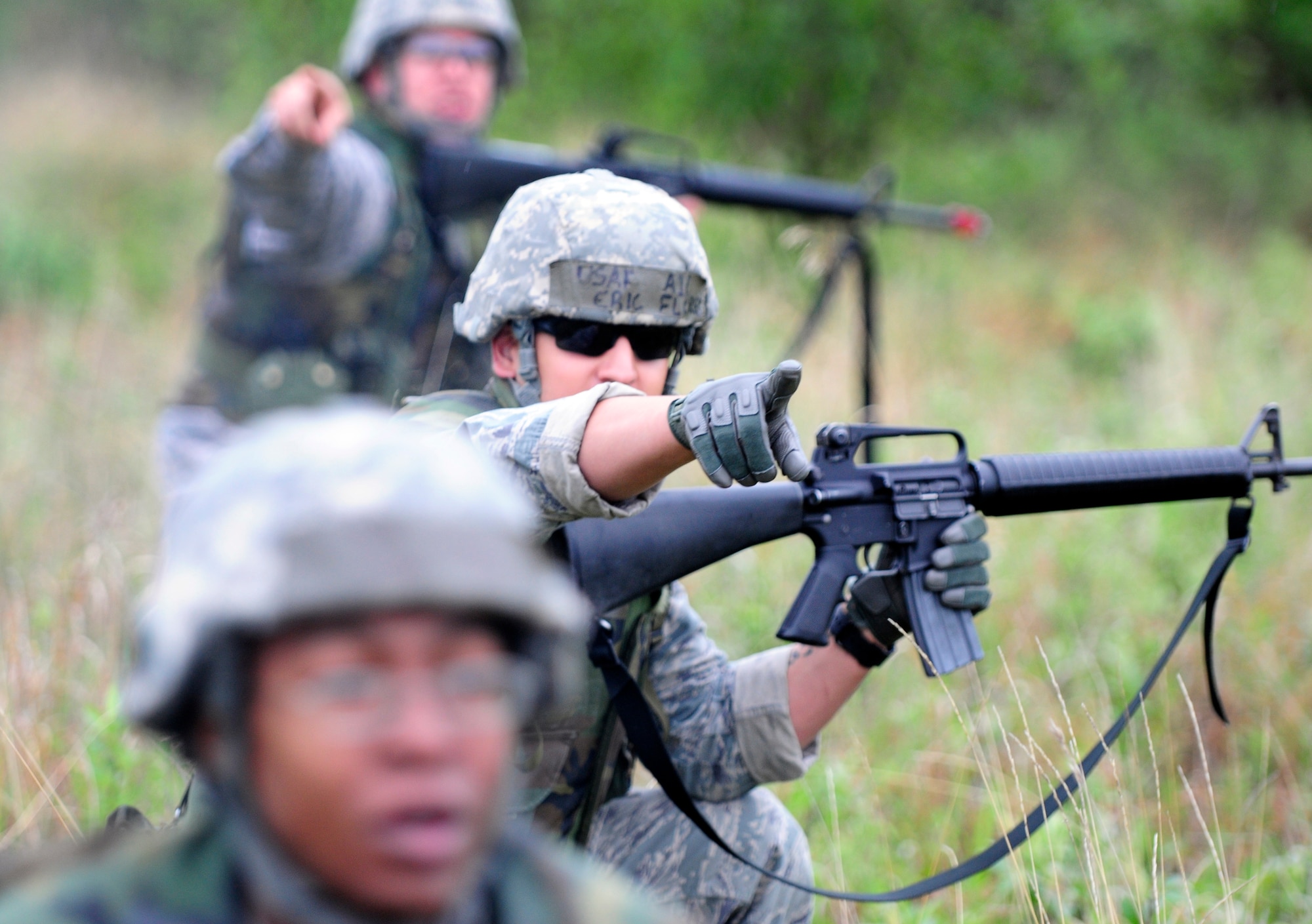 Airman 1st Class Eric Flores points to the direction of the enemy during a dismounted patrol preparedness exercise  for civil engineer Airmen June 2, 2011, Eielson Air Force Base, Alaska. The 354th Civil Engineer Squadron Explosive Ordnance Disposal flight familiarizes deploying Airmen with the fundamentals of tactical troop movement and improvised explosive devices. Airman Flores is assigned to the 354th CES. (U.S. Air Force photo/Airman 1st Class Laura Goodgame) 