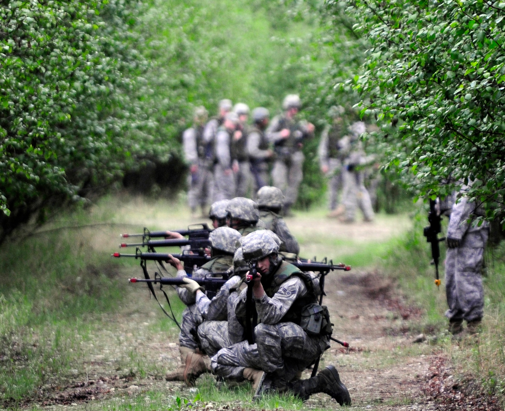 Airmen take small arms fire during a dismounted patrol preparedness exercise  for civil engineer Airmen June 2, 2011, Eielson Air Force Base, Alaska. The 354th Civil Engineer Squadron Explosive Ordnance Disposal flight familiarizes deploying Airmen with the fundamentals of tactical troop movement and improvised explosive devices. The Airmen are assigned to the 354th CES. (U.S. Air Force photo/Airman 1st Class Laura Goodgame) 