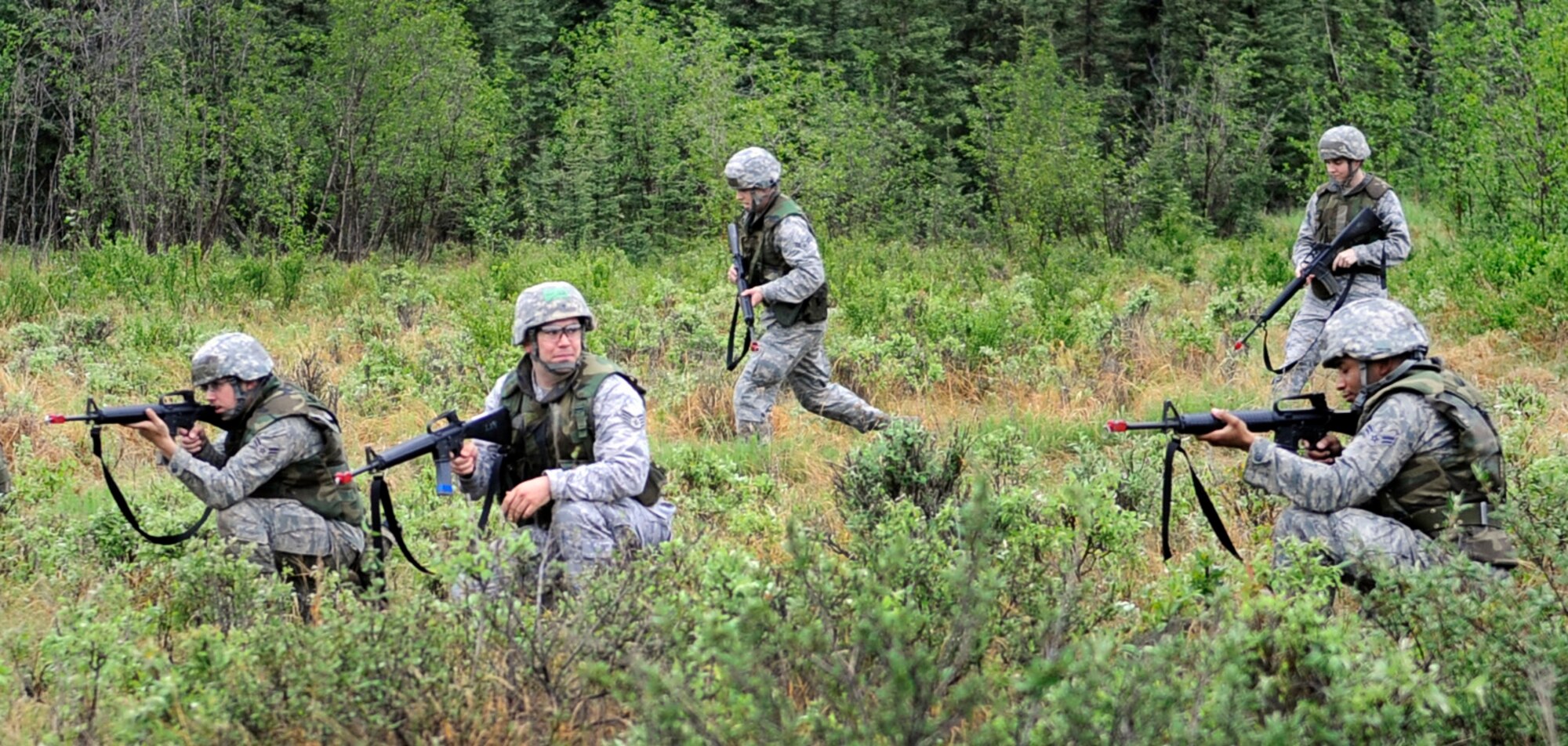 Airmen keep an eye out during a dismounted patrol preparedness exercise for civil engineer Airmen June 2, 2011, Eielson Air Force Base, Alaska. The 354th Civil Engineer Squadron Explosive Ordnance Disposal flight familiarizes deploying Airmen with the fundamentals of tactical troop movement and improvised explosive devices. The Airmen are assigned to the 354th CES. (U.S. Air Force photo/Airman 1st Class Laura Goodgame) 