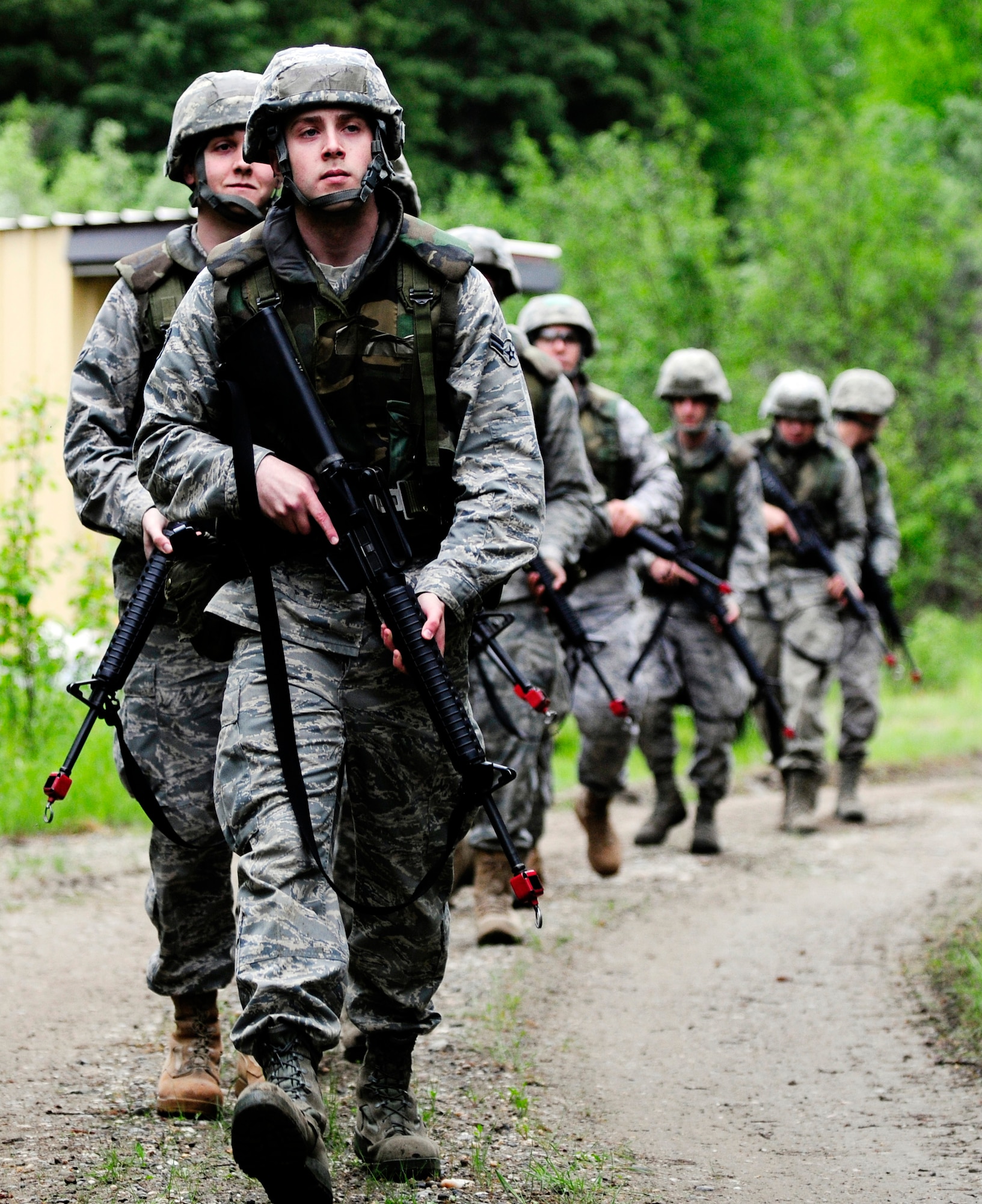 Airmen keep an eye out during a dismounted patrol preparedness exercise for civil engineer Airmen June 2, 2011, Eielson Air Force Base, Alaska. The 354th Civil Engineer Squadron Explosive Ordnance Disposal flight familiarizes deploying Airmen with the fundamentals of tactical troop movement and improvised explosive devices. The Airmen are assigned to the 354th CES. (U.S. Air Force photo/Airman 1st Class Laura Goodgame) 