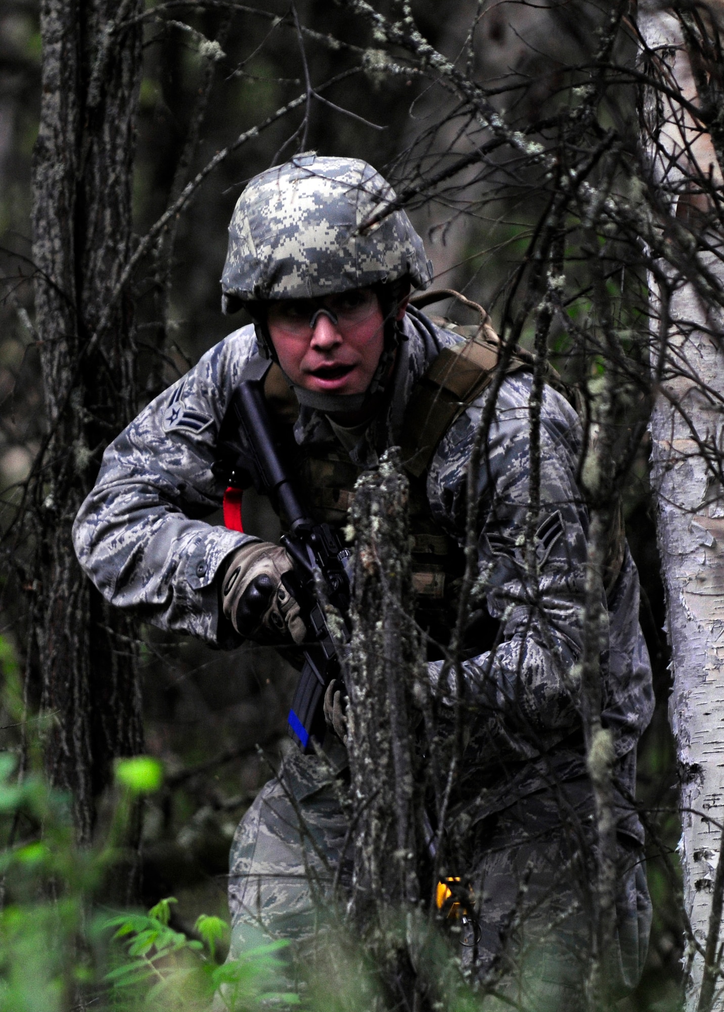 Airman 1st Class Jordan Burger prepares to fire his weapon during a dismounted patrol preparedness exercise for civil engineer Airmen June 2, 2011, Eielson Air Force Base, Alaska. The 354th Civil Engineer Squadron Explosive Ordnance Disposal flight familiarizes deploying Airmen with the fundamentals of tactical troop movement and improvised explosive devices. Airman Burger is assigned to the 354th CES EOD flight. (U.S. Air Force photo/Airman 1st Class Laura Goodgame)