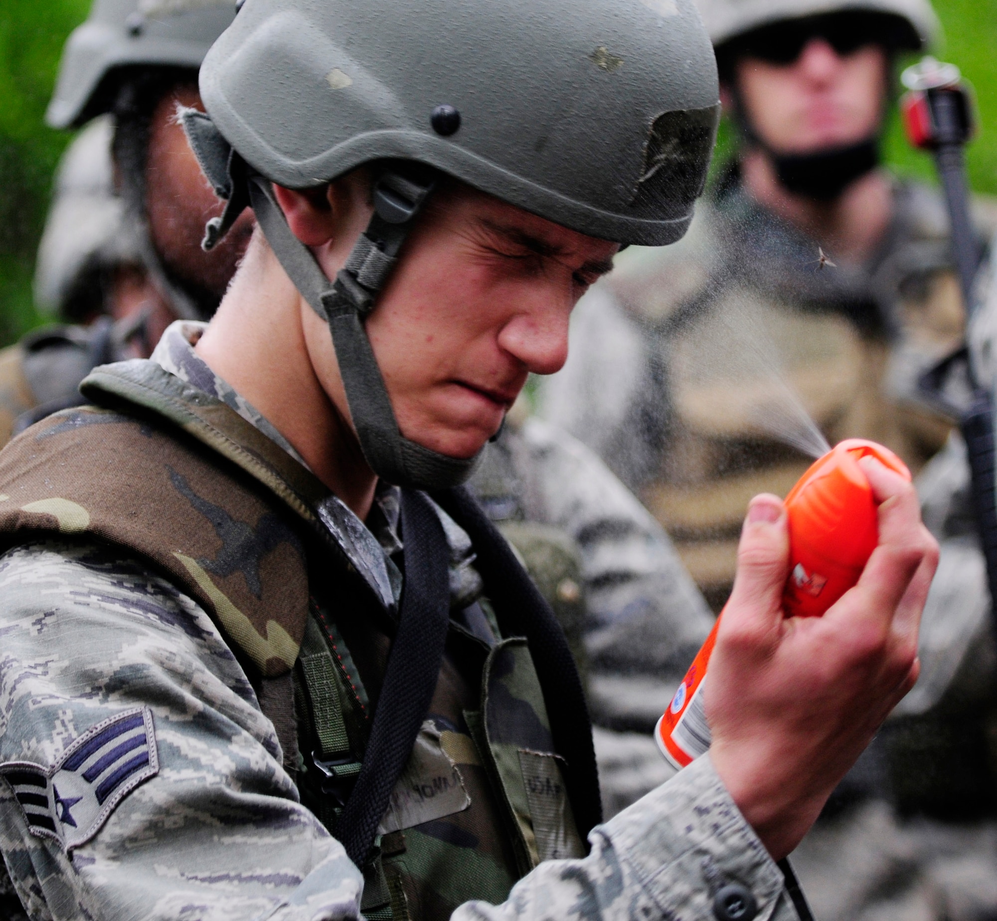 Senior Airman John Nary sprays mosquito repellant onto his exposed skin during a dismounted patrol preparedness exercise for civil engineer Airmen June 2, 2011, Eielson Air Force Base, Alaska. Training in the Alaska wilderness  can be miserable without proper clothing and bug repellant. The 354th Civil Engineer Squadron Explosive Ordnance Disposal flight familiarizes deploying Airmen with the fundamentals of tactical troop movement and improvised explosive devices. Airman Nary is assigned to the 354th CES. (U.S. Air Force photo/Airman 1st Class Laura Goodgame) 