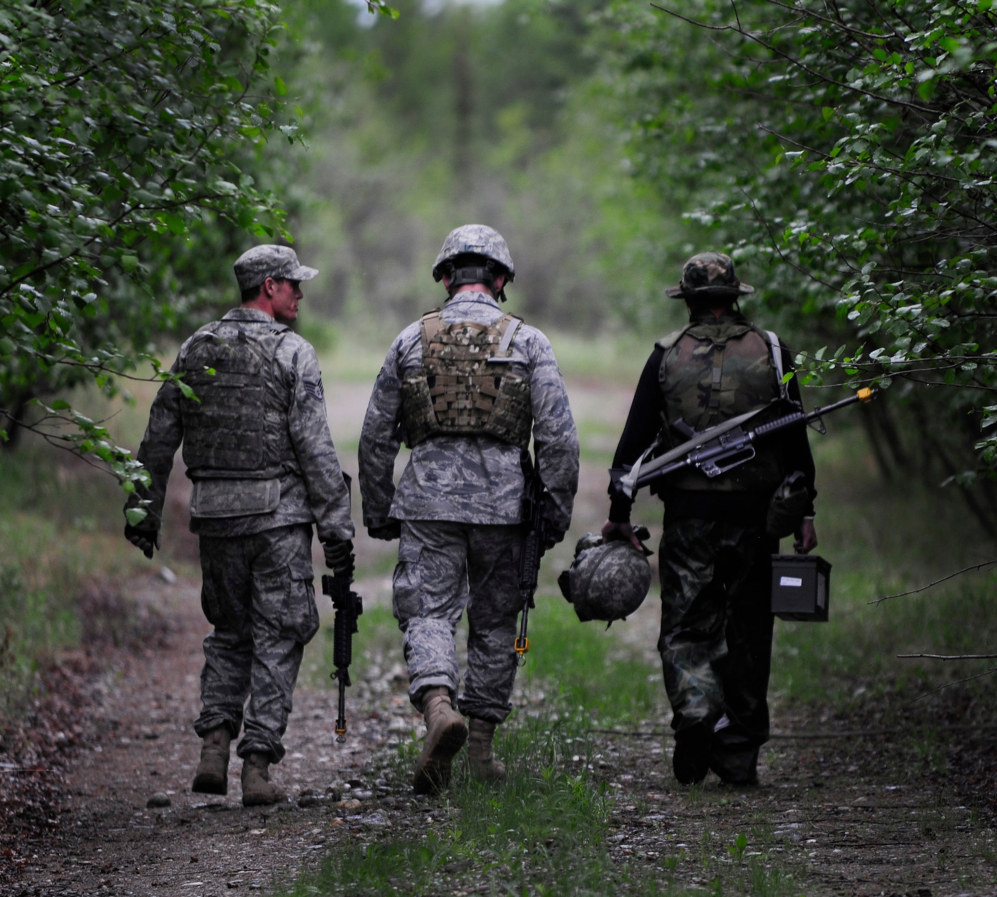 Staff Sgt. Devin Long informs Airman 1st Class Jordan Burger and Tech Sgt. Michael Cherry where explosives are buried during a dismounted patrol preparedness exercise for civil engineer Airmen June 2, 2011, Eielson Air Force Base, Alaska. The 354th Civil Engineer Squadron Explosive Ordnance Disposal flight familiarizes deploying Airmen with the fundamentals of tactical troop movement and improvised explosive devices. Sergeant Long and Airman Burger are assigned to the 354th CES EOD flight. Sergeant Cherry is assigned to the 354th CES.  (U.S. Air Force photo/Airman 1st Class Laura Goodgame) 