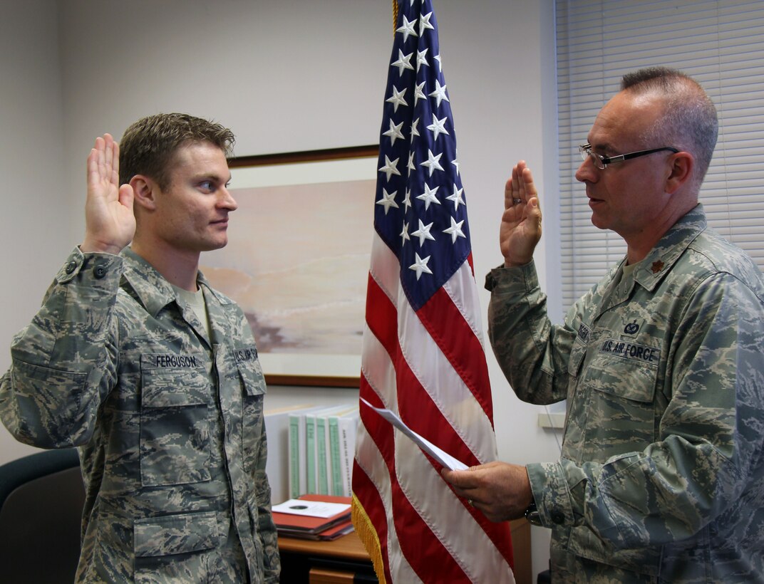 SCOTT AIR FORCE BASE, Ill--Staff Sgt. Eric Ferguson repeats the oath of enlistment with Maj. Stan Paregien at the 932nd Medical Squadron, Air Force Reserve on June 2.  The 11-year NCO said re-enlisting for six years in the 932nd MDS was a simple decision.  "The leadership and people here care and watch out for you.  As a medical unit we go all over the world to help people.  I take a lot of pride in that," he said.  (U.S. Air Force photo/Tech. Sgt. Dan Oliver)