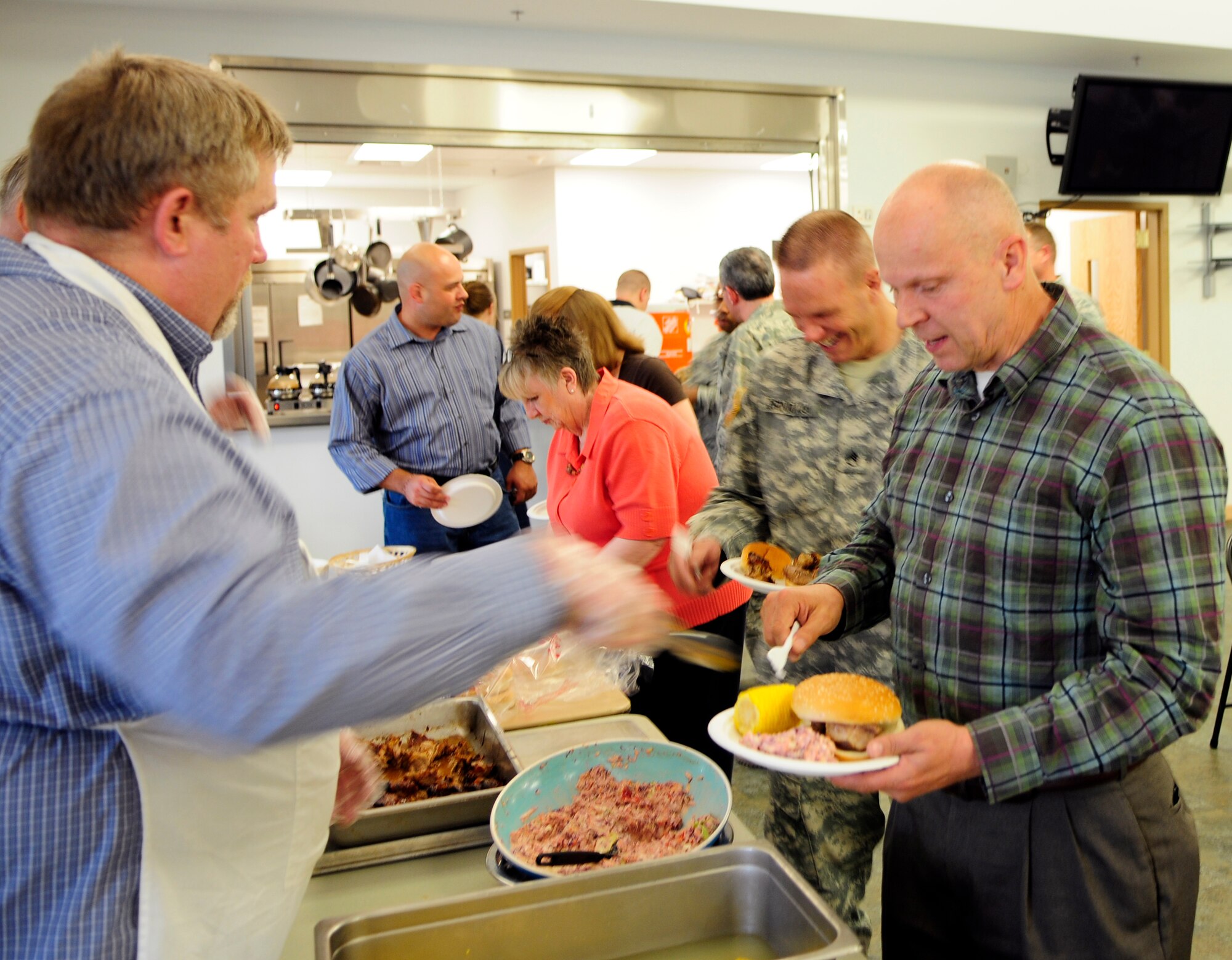 Volunteers serve members of the local community at the Chapel Fellowship Hall June 3, 2011, Eielson Air Force Base, Alaska.  Together, Eielson and Fort Wainwright organized the religious community to partake in fellowship activities further solidifying a sense of community.  (U.S. Air Force photo/Airman 1st Class Yash Rojas)