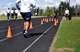 A runner sprints a 50-meter portion of the track during the McChord Health and Wellness Center running clinic May 23 at Joint Base Lewis-McChord, Wash. After their sprint is recorded, their footage is analyzed and they receive feedback via e-mail on how to improve their stride and mechanics. (U.S. Air Force photo/Airman 1st Class Leah Young)