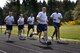 A group of runners begin their warm-up lap before participating in the McChord Health and Wellness Center running clinic May 23 at Joint Base Lewis-McChord, Wash. Runners complete one lap before the clinic to loosen their muscles.  (U.S. Air Force photo/Airman 1st Class Leah Young)