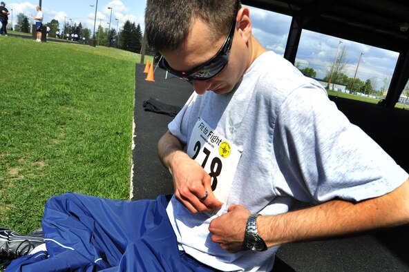 Senior Airman Daniel Boling applies his ‘Fit to Fight’ number before participating in the McChord Health and Wellness Center running clinic May 23 at Joint Base Lewis-McChord, Wash. (U.S. Air Force photo/Senior Airman Frances Kriss) 