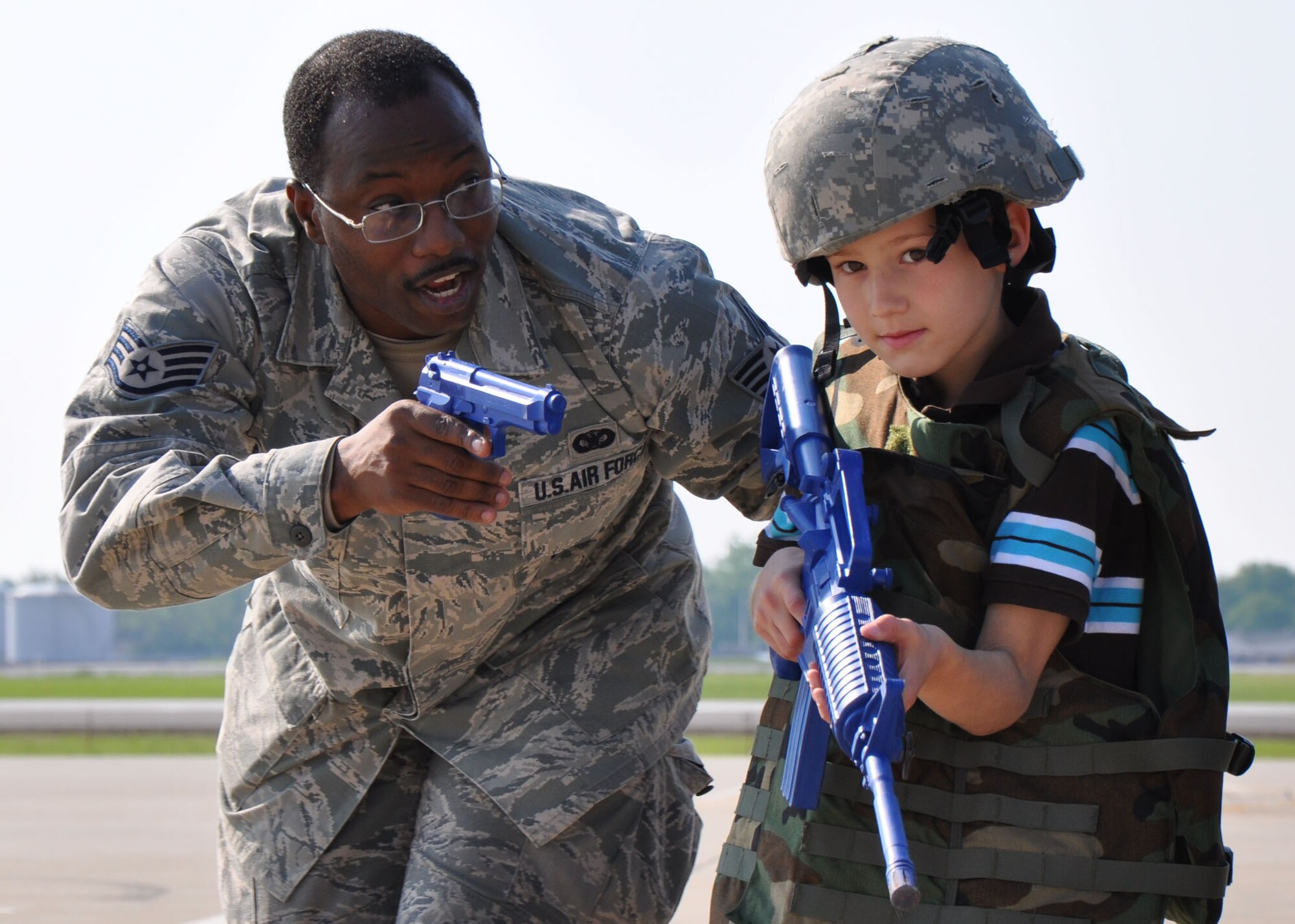 WRIGHT-PATTERSON AIR FORCE BASE, Ohio - Staff Sgt. Nasir Ahmad, 88th Security Forces Squadron, helps a Boy Scout turn a corner to a Humvee with weapons protection May 21.  Scouts from Indiana, Kentucky and Ohio visited the 445th Airlift Wing to participate in the Scouts Day event here. The Scouts toured a C-5 Galaxy plus hands-on demonstrations were given by the 445th and 88th SFS, 445th Aeromedical Evacuation Squadron, and flight crew members. (U.S. Air Force photo/Staff Sgt. Robert Nelson)
