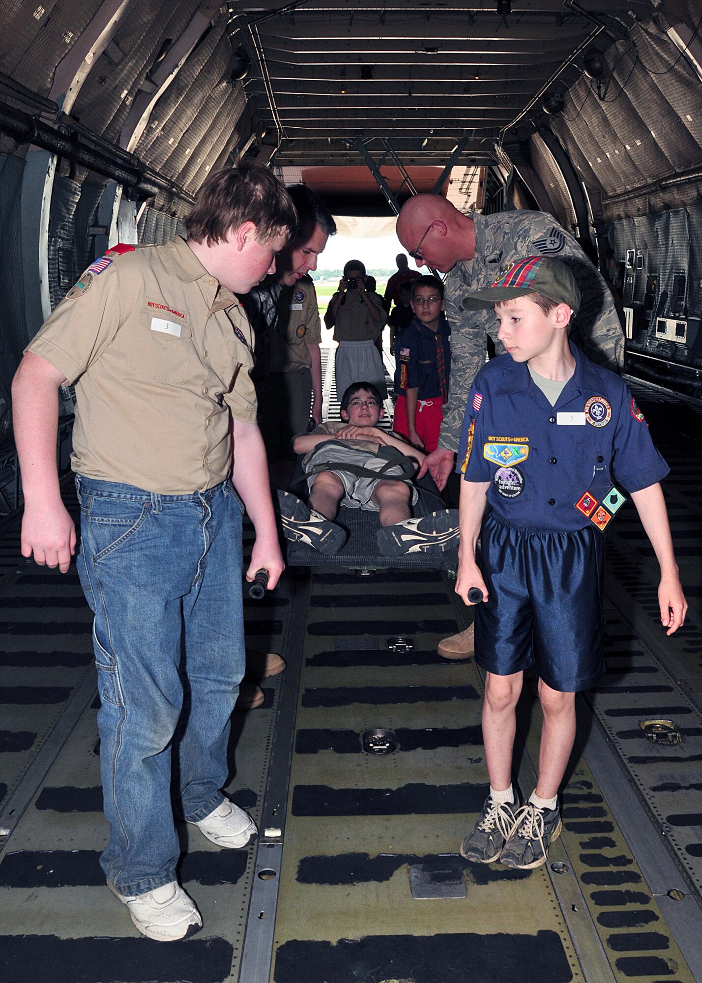 WRIGHT-PATTERSON AIR FORCE BASE, Ohio - Technical Sgt. Nathan Hutchinson, 445th Air Evacuation Squadron, lets a group of Scouts carry a patient litter during the 445th Airlift Wing’s Scout Day May 21.  Scouts day provides an opportunity for Boy and Girl Scout troops to come and experience what the Air Force does. (U.S. Air Force photo/Staff Sgt. Amanda Duncan)
