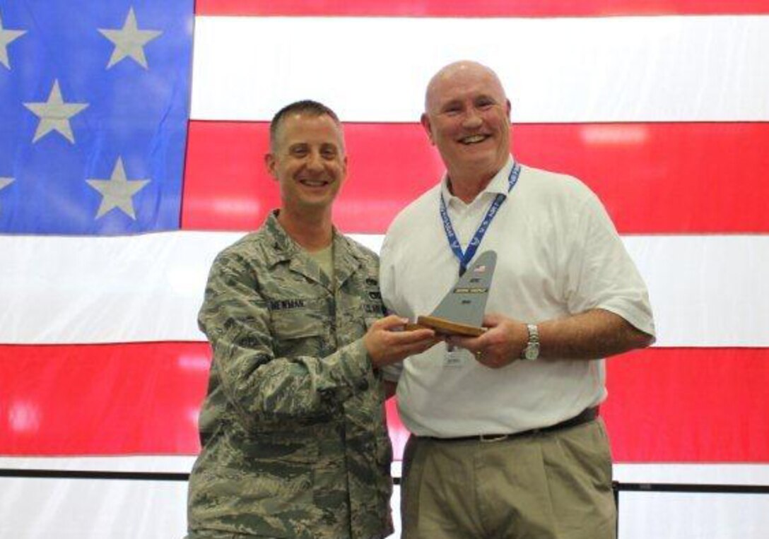Col. Brett Newmann, 934th Maintenance Group commander, presents Honorary Commander Steve Kane with a tail flash during the June UTA.  Kane will finish his two year term as honorary commander later this month.  (Courtesy Photo)
