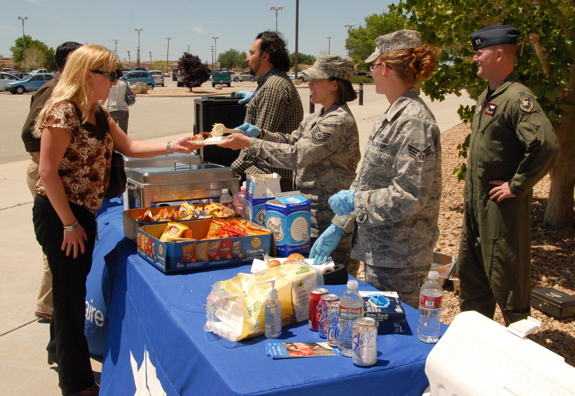Edwards Air Force Assistance Fund volunteers hand out chicken lunches April 28 in front of the Base Exchange. Club Muroc catered the lunch, which was held to raise funds for AFAF through donations. The Edwards AFAF campaign ended May 6 meeting 115 percent of its goal. This year's goal was set at $54, 317 with the final tally being $62,488.65. (Air Force photo by Kenji Thuloweit)