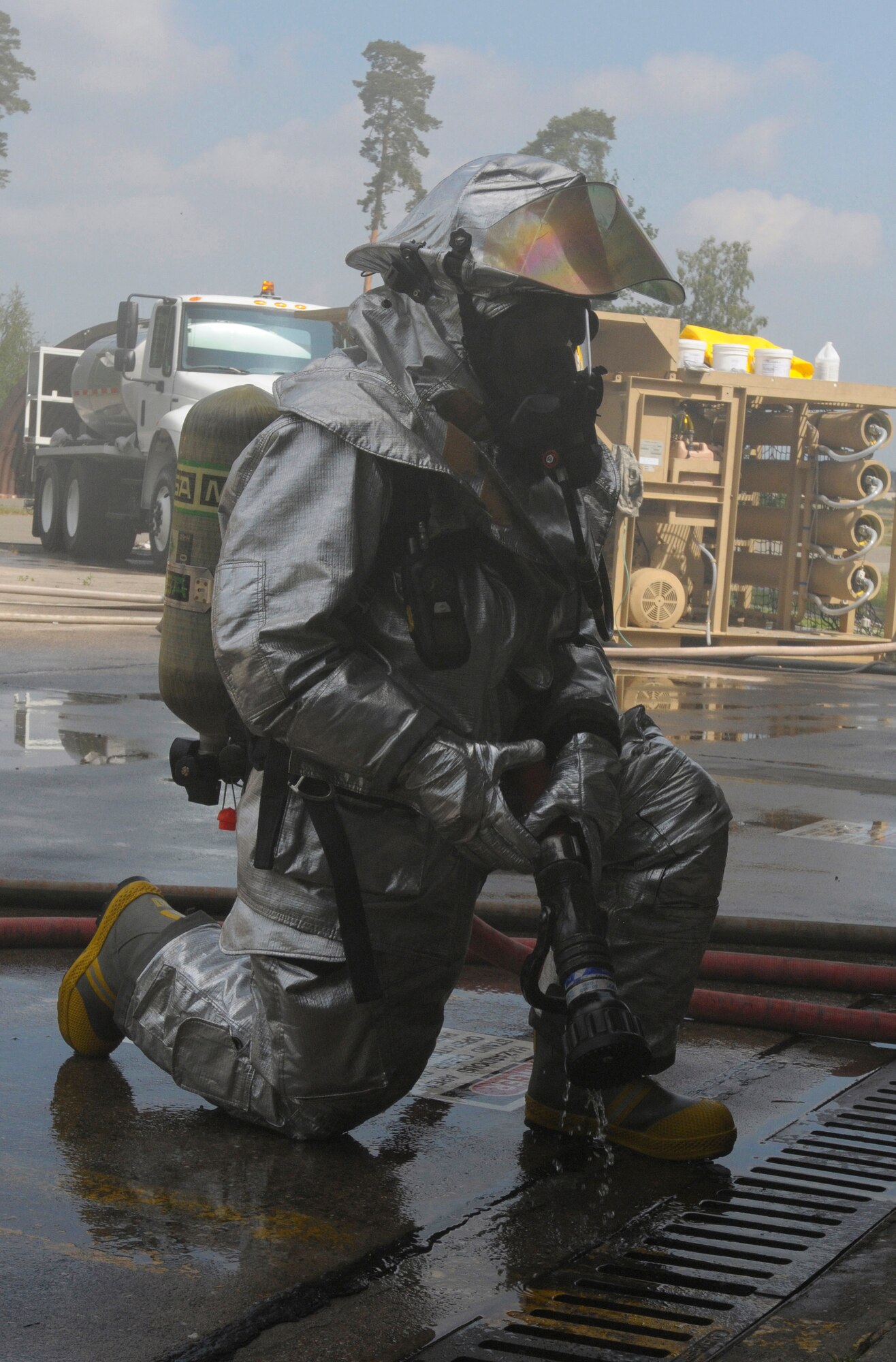 U.S. Air Force Airmen 1st Class Ronald Brown, 31st Civil Engineer Squadron, Aviano Air Base, Italy, prepares for an exercise inject during Silver Flag, Ramstein Air Base, Germany, June 7, 2011. The exercise inject consisted of several simulated scenarios that included victim rescue and uncontained fires. Silver Flag is a weeklong training program for Airmen from various bases; it combines classroom and practical application exercises to prepare Airmen for deployment. (U.S. Air Force photo by Airman 1st Class Desiree Esposito)