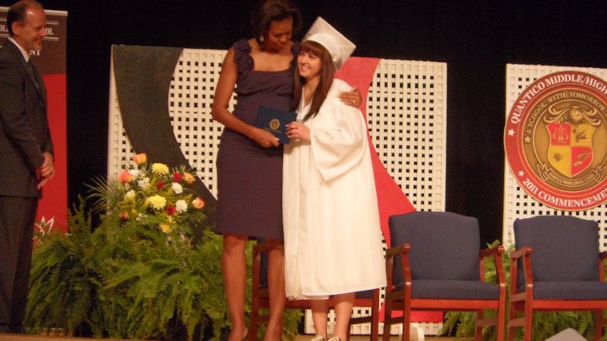 Sabrina Cavazos receives her diploma and a hug from first lady Michelle Obama during the Quantico Middle/High School graduation ceremony on Marine Corps Base Quantico, Va., June 3, 2011. Sabrina, a Robert D. Edgren student from Misawa Air Base, Japan, plans to attend Texas A&M University. (Courtesy Photo)