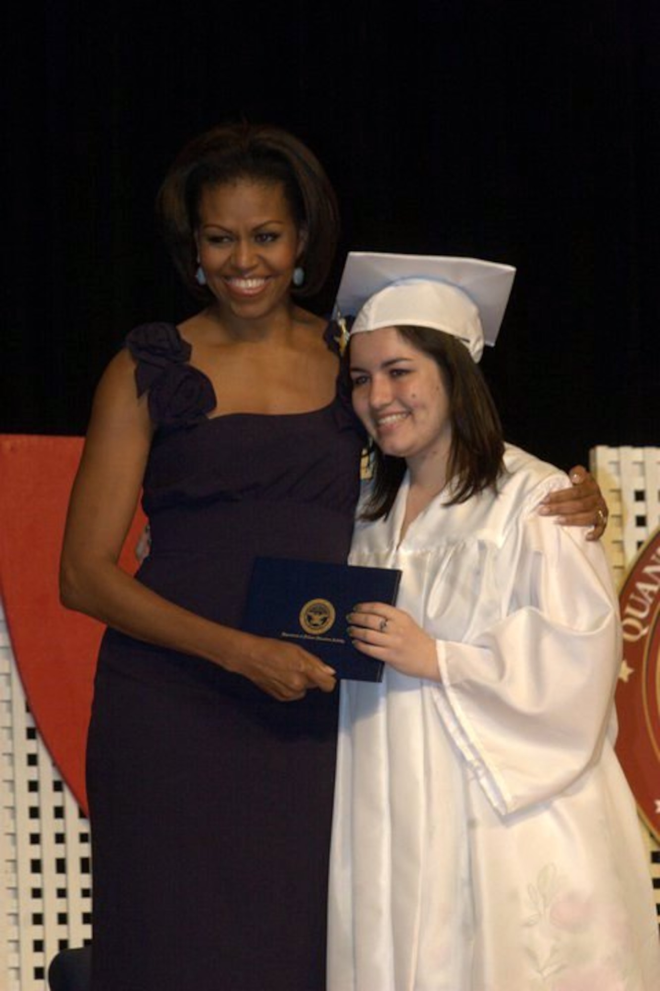 Gabriella Cuebas receives her diploma and a hug from first lady Michelle Obama during the Quantico Middle/High School graduation ceremony on Marine Corps Base Quantico, Va., June 3, 2011. Gabriella, a Robert D. Edgren student from Misawa Air Base, Japan, plans to attend community college for a year before transferring to a university. (Courtesy Photo)