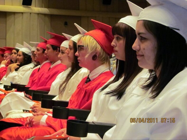 From right to left, Gabriella Cuebas, Sabrina Cavazos and seven other students from Japan listen to a commencement address by first lady Michelle Obama during the Quantico Middle/High School graduation ceremony on Marine Corps Base Quantico, Va., June 3, 2011. Nine students who had departed Japan earlier this year were invited to participate in the Quantico ceremony. (Courtesy Photo)