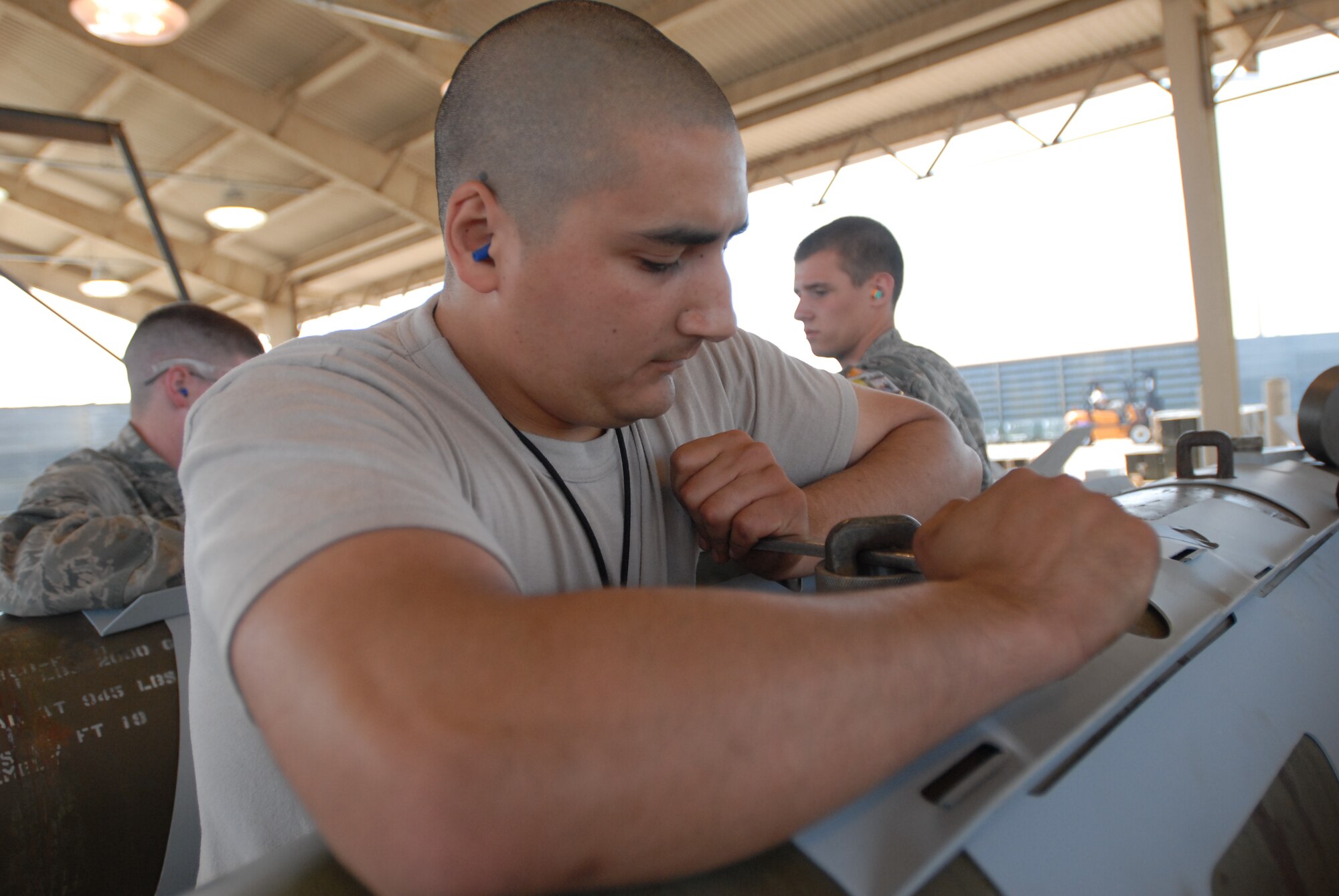 KUNSAN AIR BASE, Republic of Korea -- Staff Sgt. Felipe Hernandez, 8th Maintenance Squadron conventional maintenance crew chief, prepares bombs for transport after assembly during the Combat Ammunition Production Exercise here June 7. (U.S. Air Force photo/Master Sgt. Sonny Cohrs)
