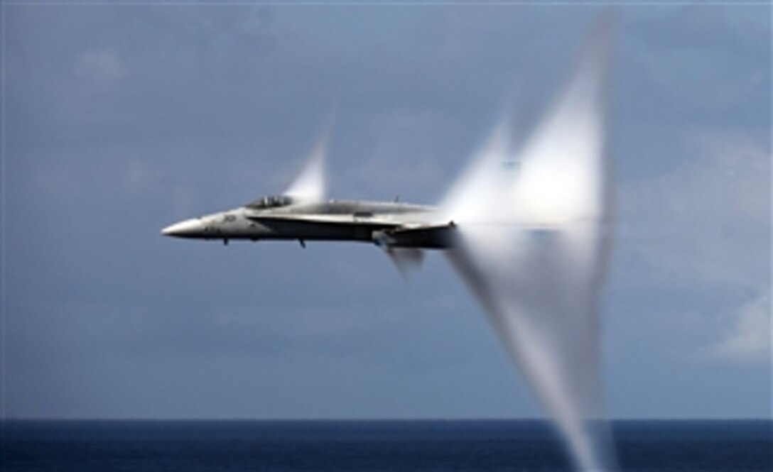 An F/A-18C Hornet assigned to Strike Fighter Squadron 113 breaks the sound barrier during an air power demonstration over the aircraft carrier USS Carl Vinson (CVN 70) in the Pacific Ocean on June 6, 2011.  The Carl Vinson and Carrier Air Wing 17 are currently underway in the U.S. 7th Fleet area of responsibility.  