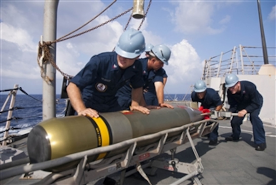 U.S. Navy sailors aboard the guided missile destroyer USS Chung-Hoon (DDG 93) load a Mark 46 torpedo into a launcher while underway in the Pacific Ocean on June 4, 2011.  The Chung-Hoon is on an independent deployment to the U.S. 7th Fleet area of responsibility.  