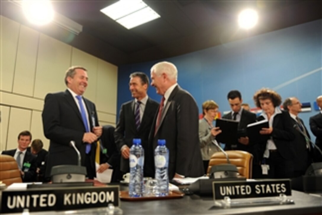 United Kingdom's Secretary of State for Defense Liam Fox (standing left), NATO Secretary General Anders Fogh Rasmussen and Secretary of Defense Robert M. Gates (3rd from left) share a laugh prior to the start of the North Atlantic Council meeting during the NATO Defense Ministerial in Brussels, Belgium, on June 8, 2011.  
