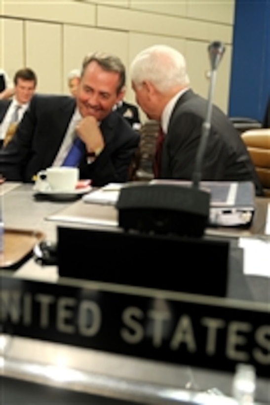 Secretary of Defense Robert M. Gates speaks with United Kingdom's Secretary of State for Defense Liam Fox during the NATO Defense Ministerial in Brussels, Belgium, on June 8, 2011.  