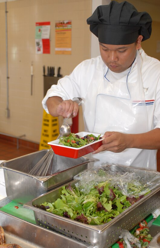 Petty Officer 2nd Class Denis Camarillio, Naval Hospital Camp Pendleton, prepares fresh green salad with grilled chicken and a mixed berry vinaigrette. Camarillo, along with his partner Petty Officer 2nd Class Matthew Gerritson, won Chef of the Quarter that was held at Duncan mess hall, Marine Corps Recruit Depot San Diego, June 8, by preparing a meal fit for a king.