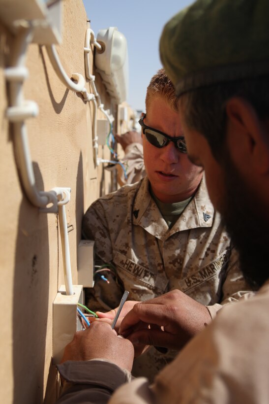 Cpl. Raymond Hewitt, a generator mechanic with Marine Wing Support Squadron 272, instructs Gholam Mohammad, an Afghan National Army soldier, on electrical wiring at an Afghan National Security Forces generator operator and maintainer course at Camp Leatherneck, Afghanistan, June 9. Hewitt, a native of Lowville, N.Y., and three other Marines with MWSS-272, instructed Afghan soldiers and police to promote their capabilities in self-sustainment.