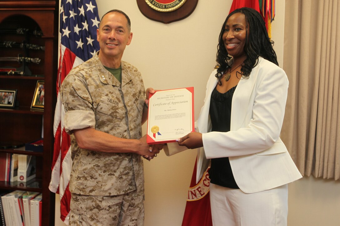 Maj. Gen. Peter J. Talleri , Marine Corps Base Camp Butler commanding general and deputy commander of Marine Corps Bases Japan, presents Melisa J. Price, the identification oversight coordinator for Installation Personnel Administration Center, Headquarters and Service Battalion, Marine Corps Base Camp Butler, with a certificate of appreciation for her hard work and dedication to her job June 10. Price has held the position since January of 2008. Her job is to be responsibility for all identification centers within Marine Corps Bases Japan to include Camps Foster, Hansen, Kinser, Courtney and Marine Corps Air Station Iwakuni.