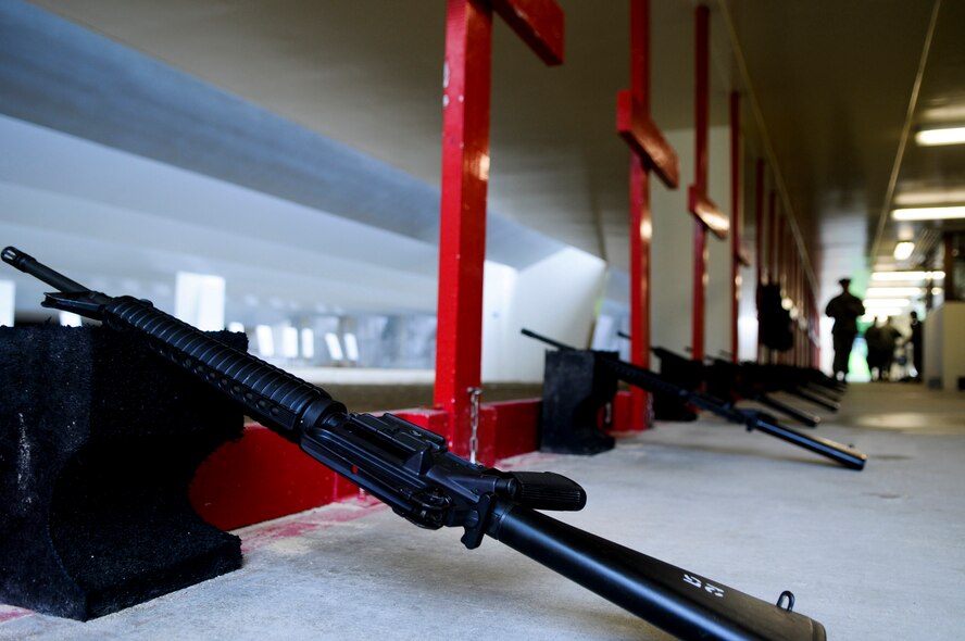 Weapons wait to be fired by qualifying Airmen at the 18th Security Forces Squadron's Combat Arms firing range May 24. Roughly 100 soon-to-deploy Airmen visit the 18th Security Forces Squadron's Combat Arms firing range each week to qualify on M-16 and M-4 rifles as well as M-9 handguns. (U.S. Air Force photo/ Airman 1st Class Maeson L. Elleman)