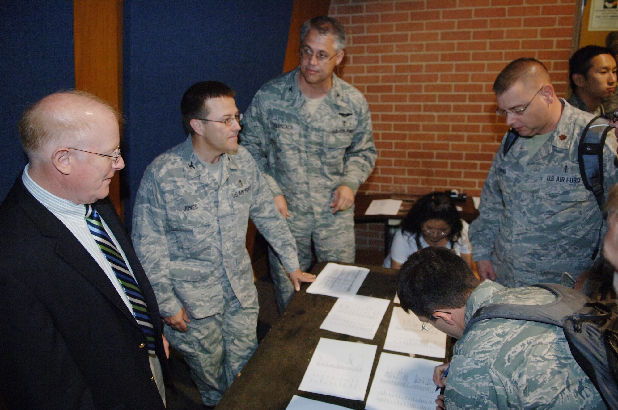 (Left to right) Dr. Kenneth Torrington, Col. (Dr.) Woodson Jones and Col. (Dr.) Randall Zernzach from the Graduate Medical Education program at Wilford Hall  greet new interns during their in processing briefing June 9. The orientation was the final one for Dr. Torrington, who retired June 10. (U.S. Air Force photo/Tech Sgt. Andy Bellamy)