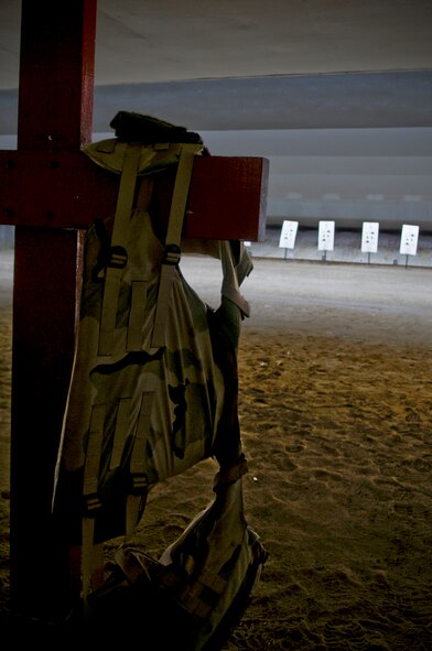 A flak vest hangs from a weapons barricade at the 18th Security Forces Squadron's Combat Arms firing range May 24. During qualification, Airmen wear flak vests, Kevlar helmets and even gas masks in a multitude of firing positions to test their abilities to hone in on targets while serving in deployed environments. (U.S. Air Force photo/ Airman 1st Class Maeson L. Elleman)
