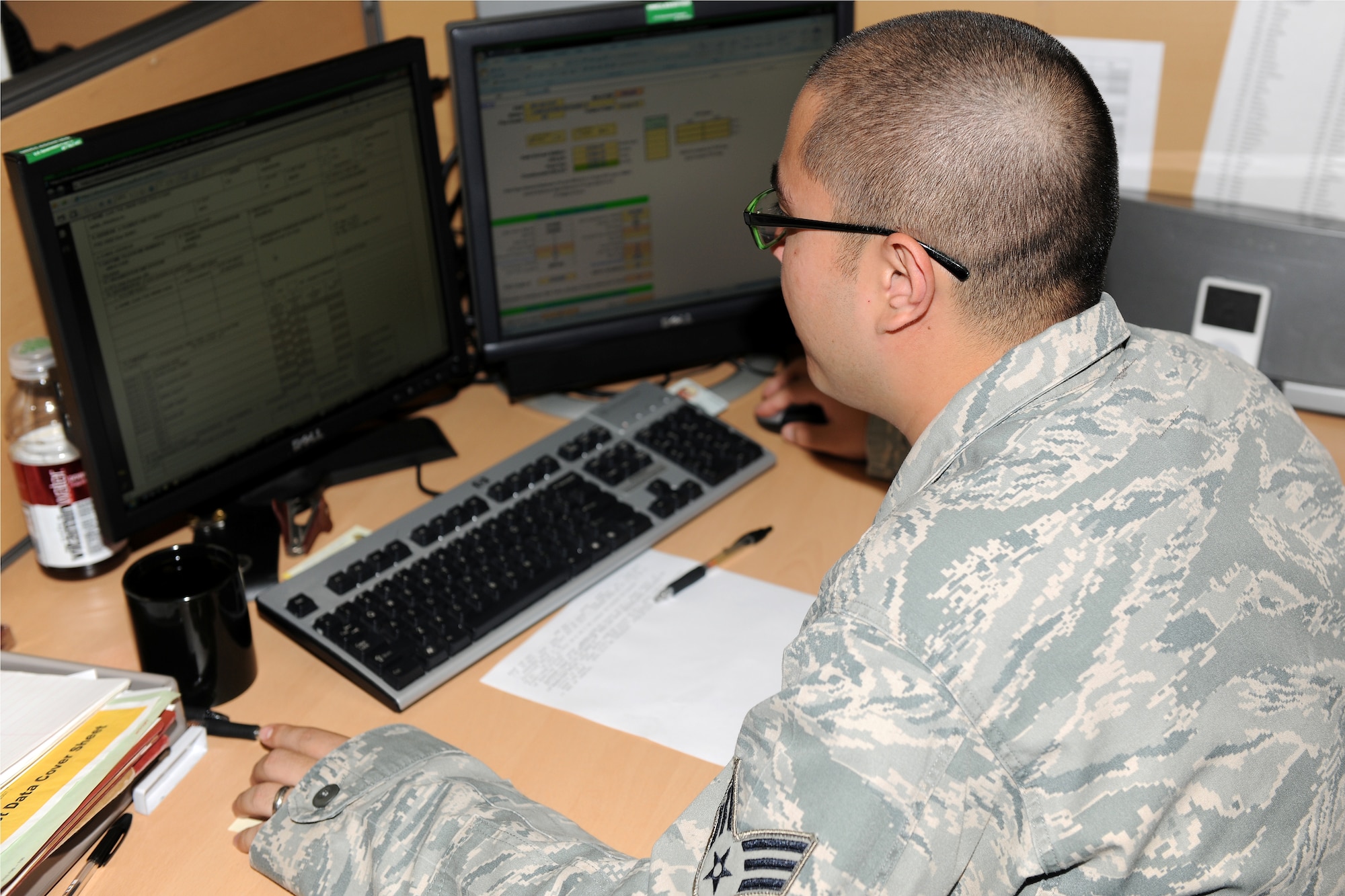 KUNSAN AIR BASE, Republic of Korea -- Senior Airman Emerson Schiess, 8th Comptroller Squadron customer support technician, reviews  financial documents for a customer here June 8. The 8th CPTS provides assistance on travel vouchers, pay information and other fianancial services and needs. (U.S. Air Force photo/Senior Airman Ciara Wymbs)