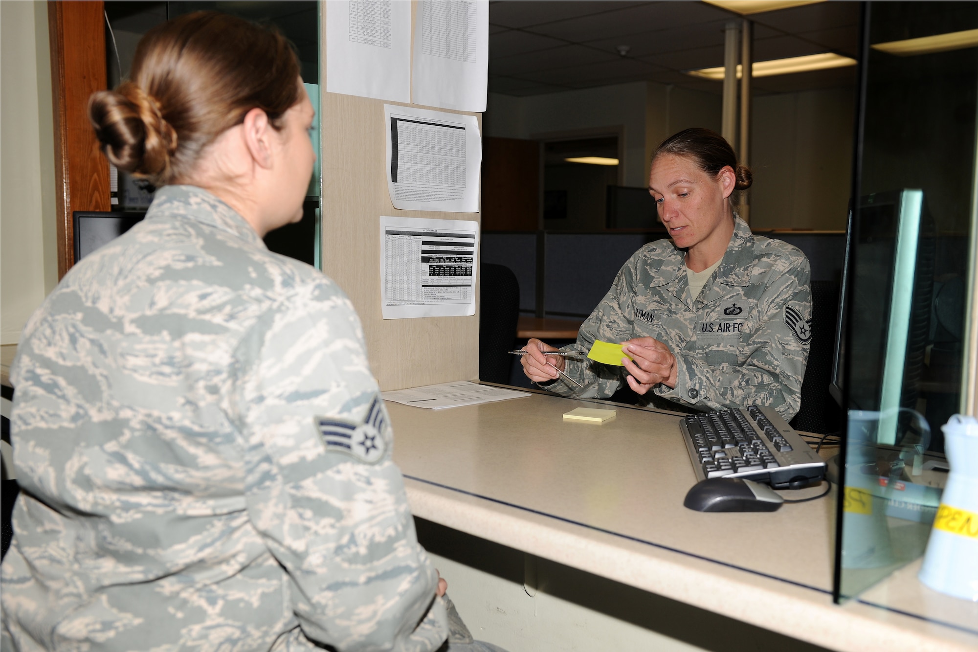 KUNSAN AIR BASE, Republic of Korea -- Staff Sgt. Jeannie Hartman, 8th Comptroller Squadron customer support supervisor, assists Senior Airman Briana Britt, 8th Maintenance Squadron aircraft fuel systems journeyman, with filing a temporary lodging allowance voucher here June 8. Members are allowed to live in lodging for up to 60 days with commander’s approval and must file vouchers within five days after arriving on station. (U.S. Air Force photo/Senior Airman Ciara Wymbs)