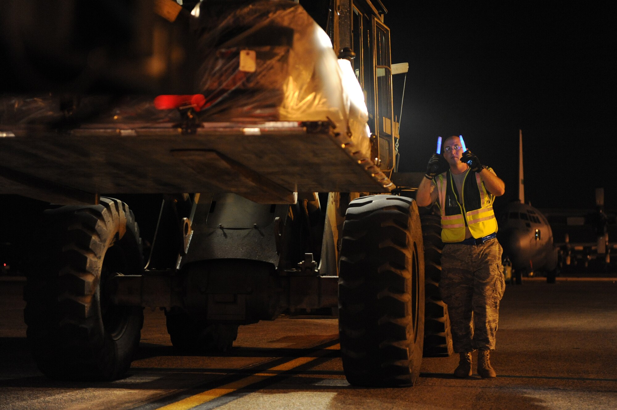 Tech. Sgt Richard Bell, 19th Logistics Readiness Squadron cargo deployment functional NCO-in-charge, gives guidance to a fellow Airman driving a forklift loading a storage conex onto a 25k loader on June 4, 2011 at Little Rock Air Force Base, Ark. during an operational readiness exercise. The exercise sharpened the skills of 19th Airlift Wing Airmen for the upcoming operational readiness inspection in October. (U.S. Air Force photo by Tech. Sgt. Chad Chisholm)