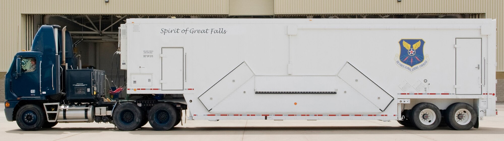 The first of nine payload transporters belonging to the 341st Maintenance Group displays a new logo paying tribute to our host city of Great Falls. By the end of the summer, all of the vehicles will have a similar logo that is a tribute to the seven counties that support Malmstrom's nuclear deterrent mission. The additional proposed logos include: Electric City Endeavor; Choteau Challenger; Cascade Crusader; Wheatland Wayfarer; Judith Basin Journeyman; Fergus Ferrier, Lewis and Clark Explorer; and Teton Traveler. (U.S. Air Force photo/Beau Wade)
