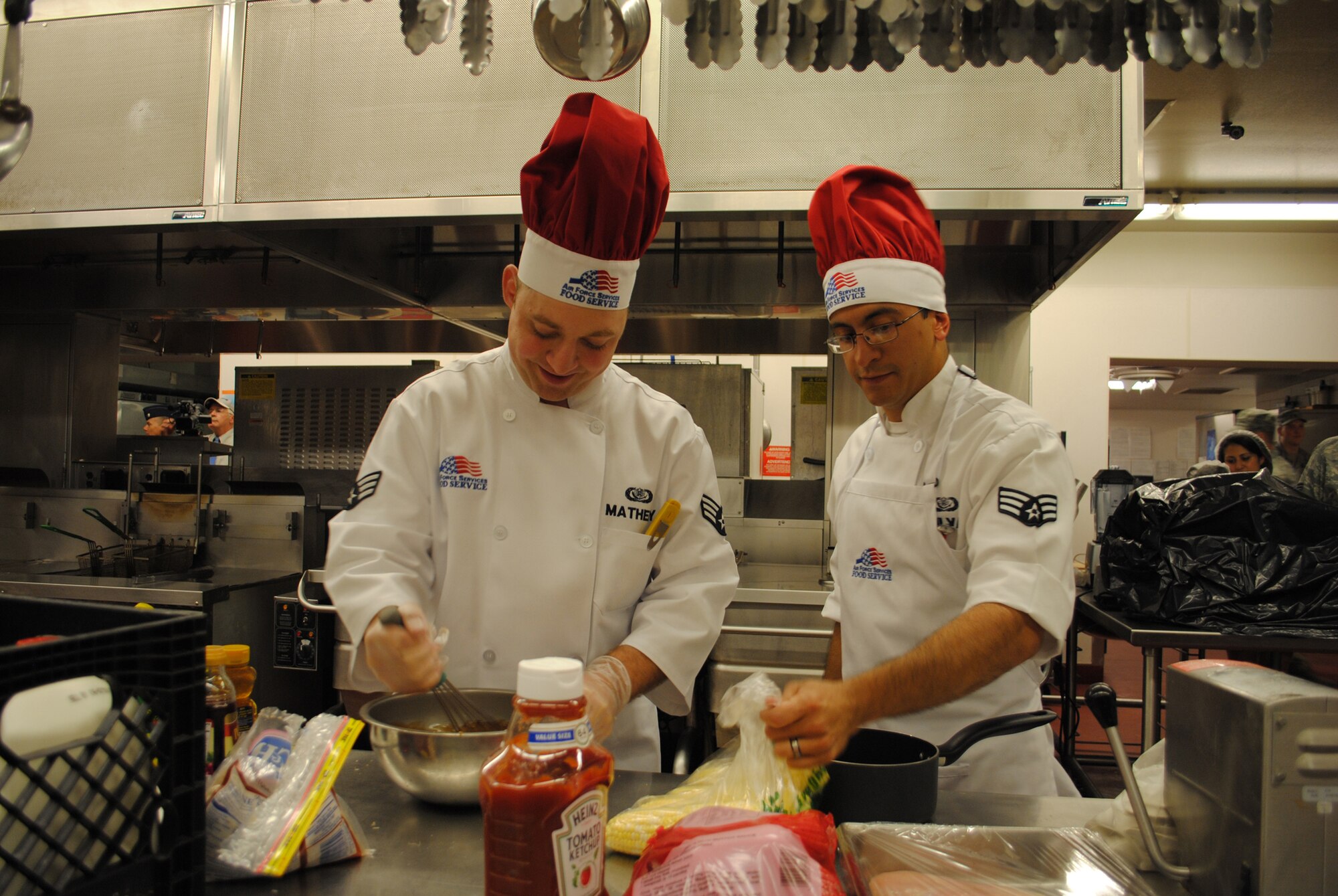 Senior Airmen Harold Matheny (left) and Josue Silva, chefs with the 341st Force Support Squadron, prepare their dish, barbeque chicken with mashed potatoes and corn, which became the eventual winner of the 2nd quarter Warrior Chef Competition. The secret ingredient for the competition was chicken.  (U.S. Air Force photo/Airman 1st Class Katrina Heikkinen)