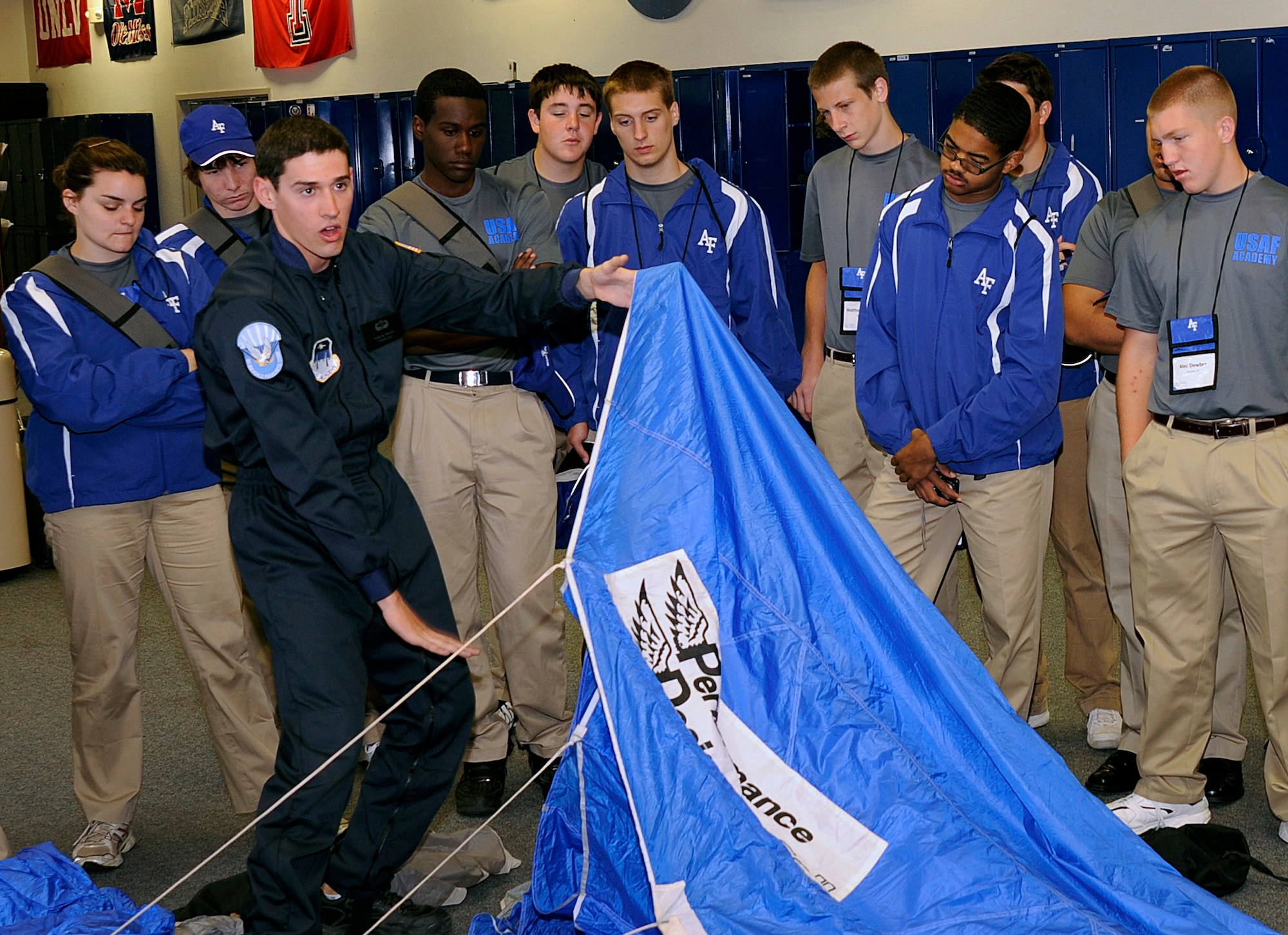 Cadet 1st Class Ryan French talks about the Air Force Academy's airmanship programs with Summer Seminar attendees at the Academy airfield June 9, 2011. Cadet French is a member of the Wings of Blue, the official Air Force parachute demonstration team, and is assigned to Cadet Squadron 17. (U.S. Air Force photo/Raymond McCoy)