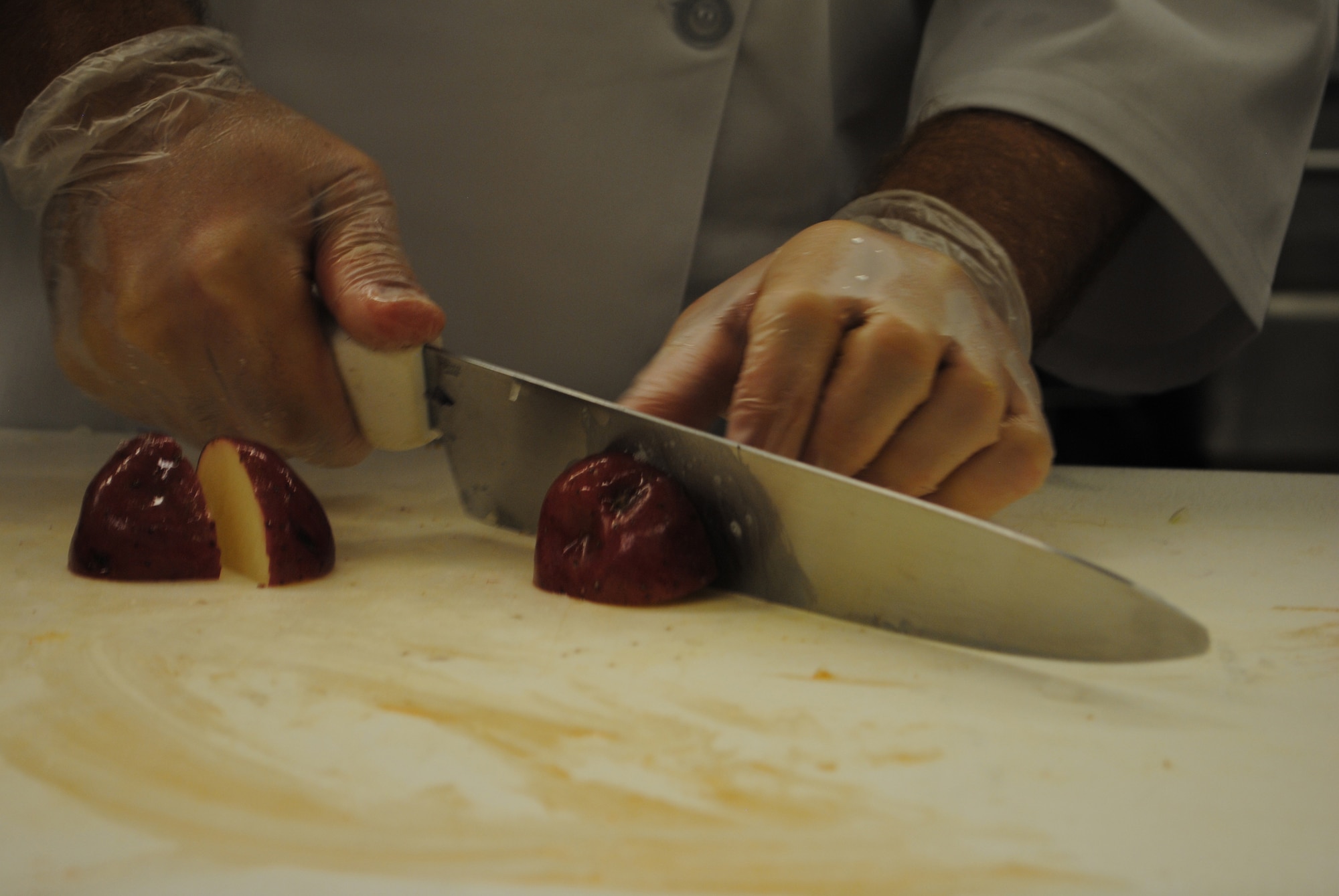 A member of the Warrior Chef competition slices a potato.  The Warrior Chef Competition is put on to showcase the talents of Malmstrom’s chefs and to provide recognition to them. (U.S. Air Force photo/Airman 1st Class Katrina Heikkinen)