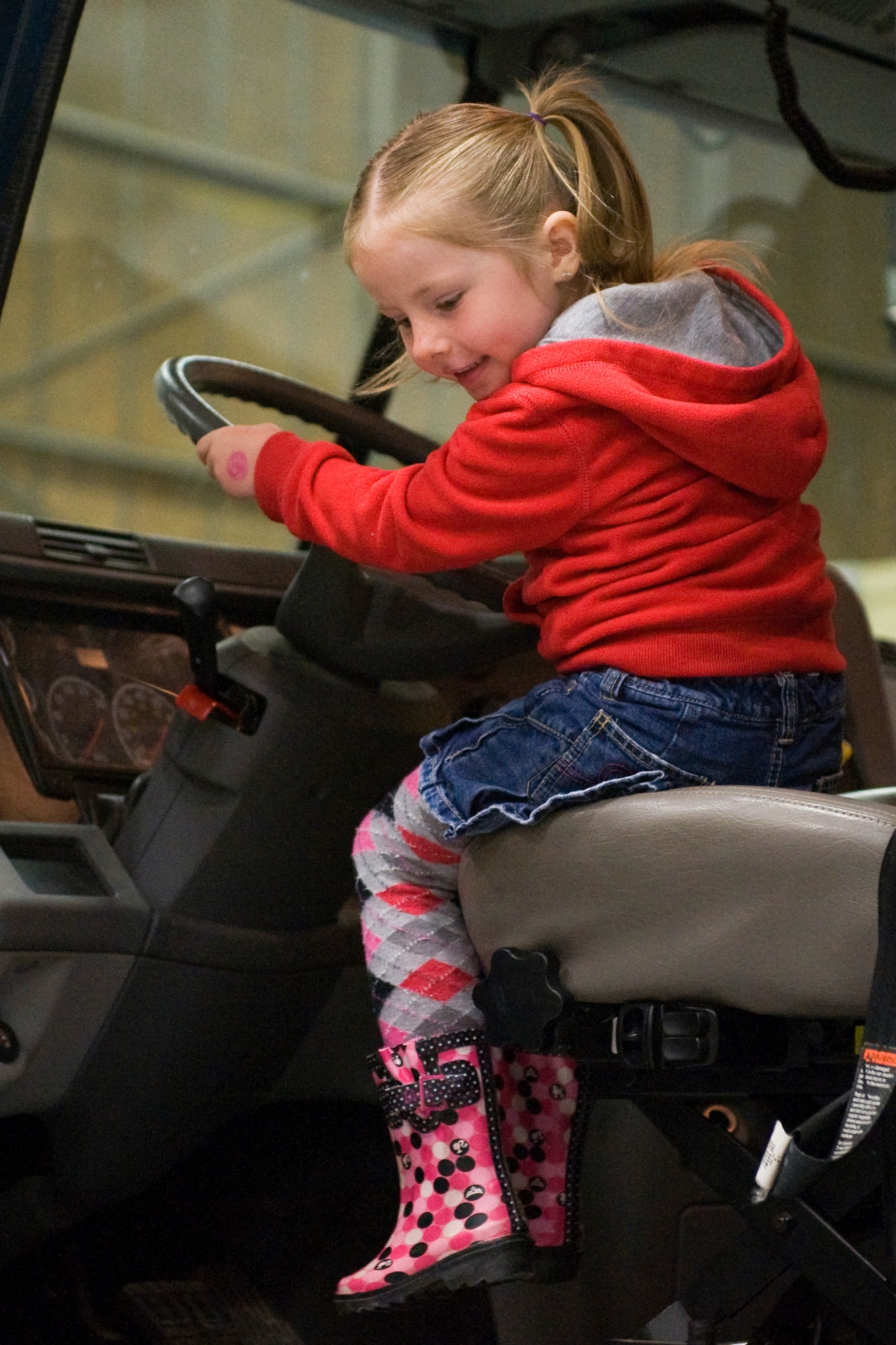 Kaylee Klos, 4, sees what it's like to drive a big rig during the open house for the 819th RHS June 3. (U.S. Air Force photo /Beau Wade)