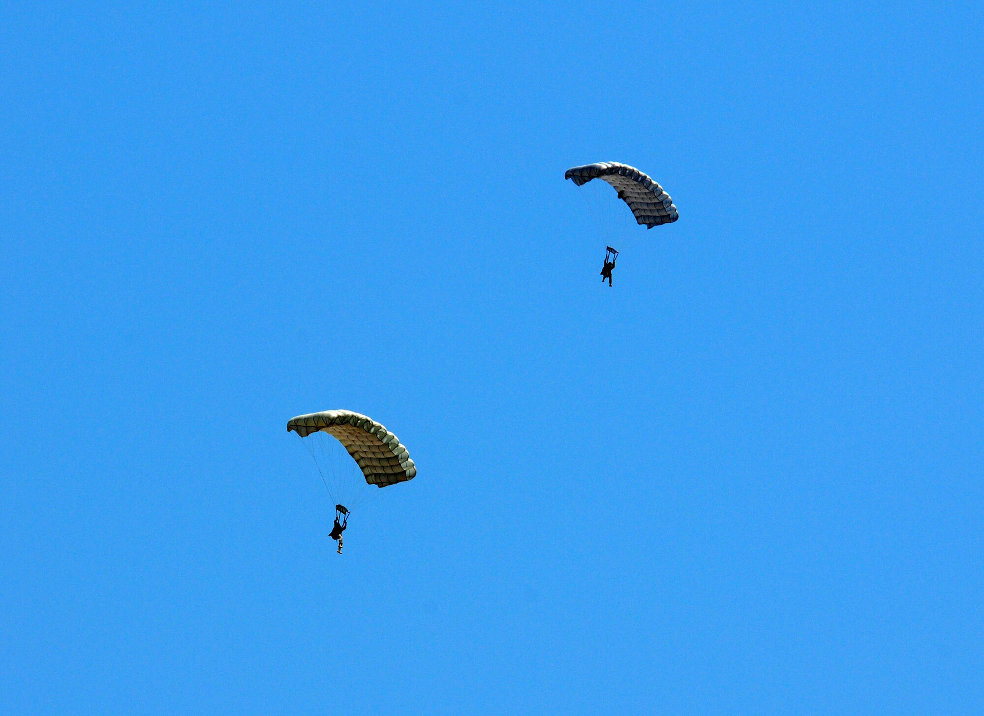 Special operations forces simulating an assault team parachute toward the ground over Melrose Air Force Range during the 27th Special Operations Wing Capabilities Exercise, June 4, 2011. Parachutists were one of many aerial and ground attractions of the CAPEX, which is an annual exhibition of the 27 SOW's many special operations aircraft and missions for Cannon Airmen and their families. (U.S. Air Force photo by Staff Sgt. Nicholas Phelps)(RELEASED)
