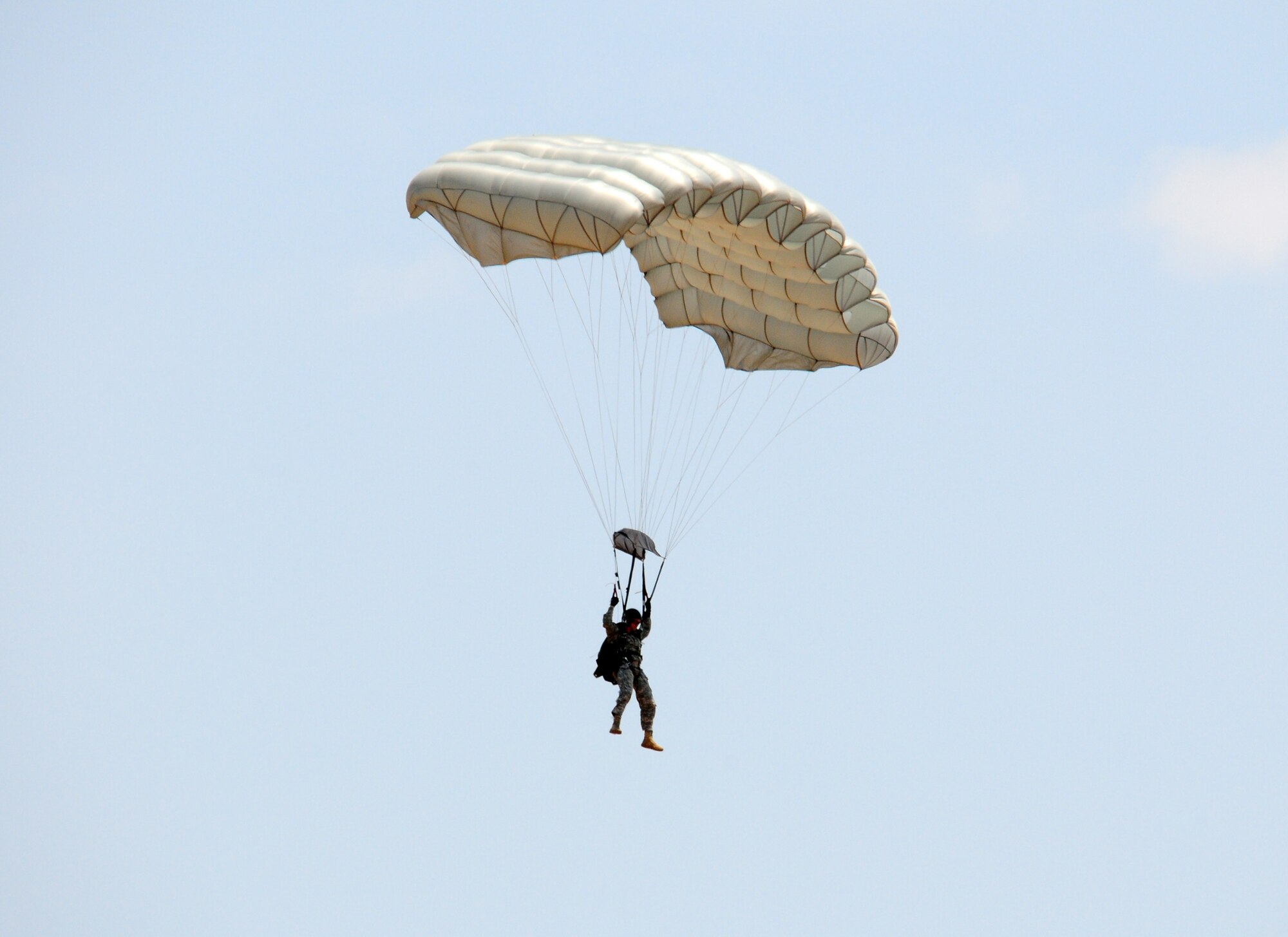 A scenario participant simulating an assault team member parachutes toward the ground over Melrose Air Force Range during the 27th Special Operations Wing Capabilities Exercise, June 4, 2011. Parachutists were one of many aerial and ground attractions of the CAPEX, which is an annual exhibition of the 27 SOW's many special operations aircraft and missions for Cannon Airmen and their families. (U.S. Air Force photo by Staff Sgt. Nicholas Phelps)(RELEASED)